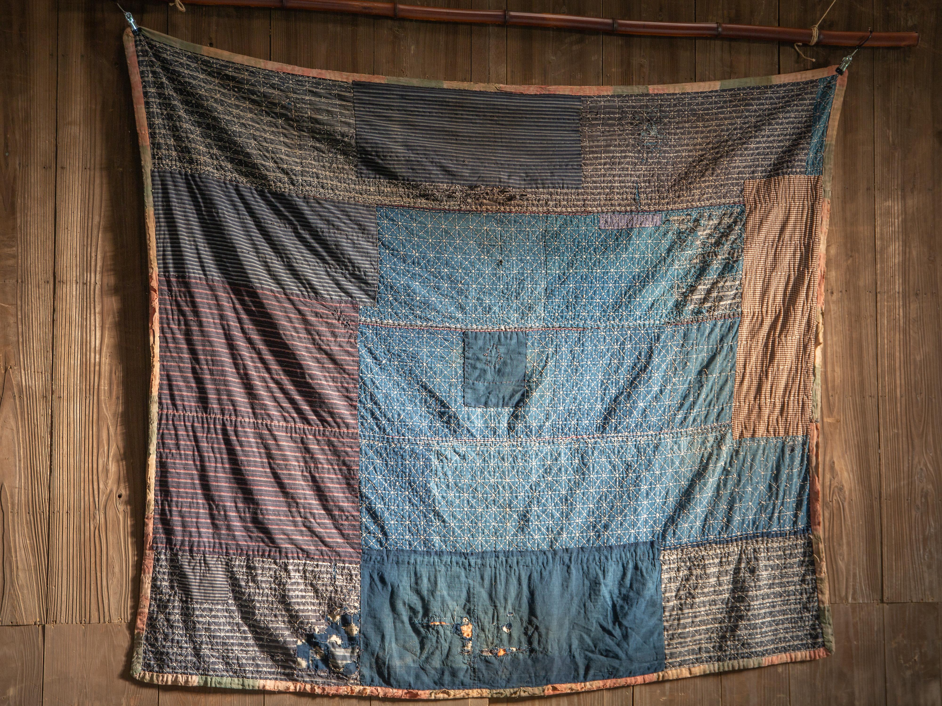 From Tohoku area, Japan.

Antique indigo Boro textile with Sashiko stitching , probably used as Kotatsu Futon (Thick blanket for brazier table) estimate from the size & condition. 3 to 4 layers of cotton / linen clothes are patched & quilted