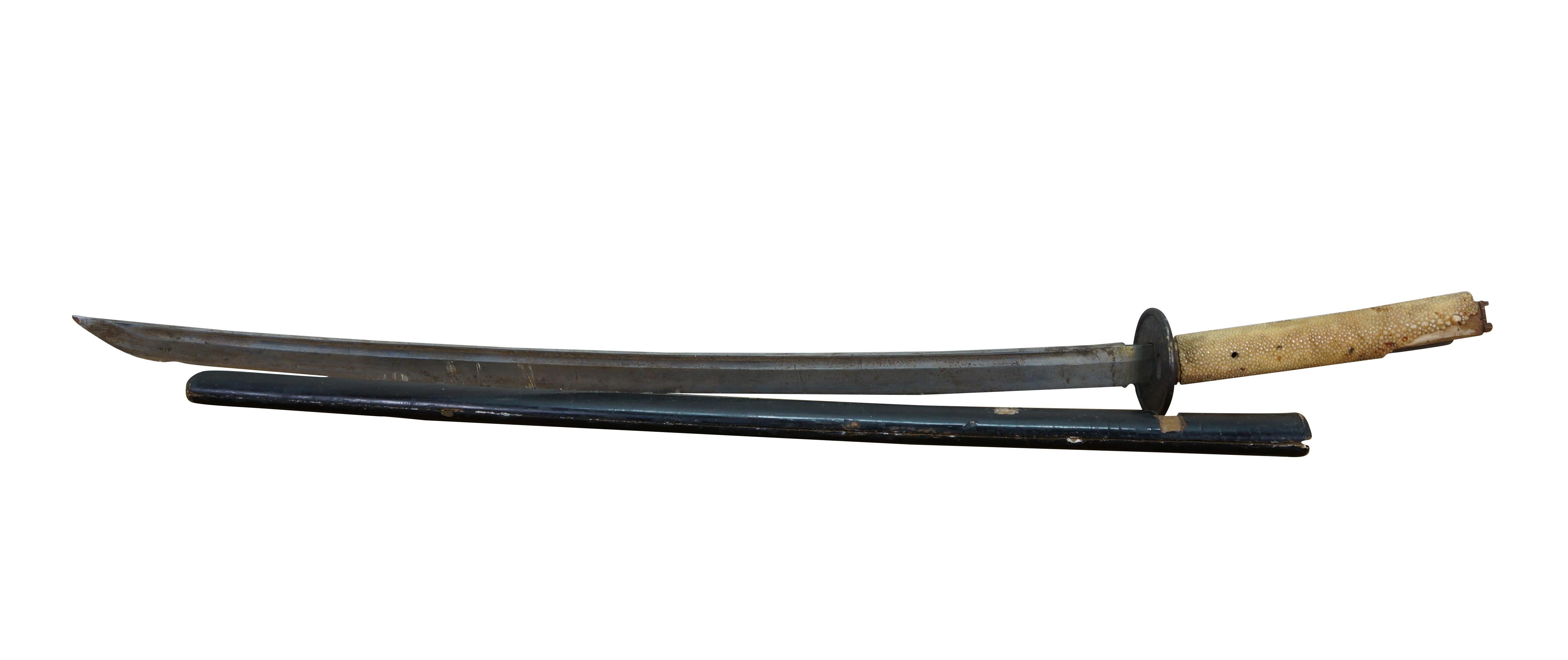 Antique Japanese katana / samurai sword. Same / white rayskin over wood on the tsuak (handle / hilt. Tsuba (guard) etched with flowers and dragons. Nakago (tang) signed. Black lacquered wood saya (scabbard).

Ray skin, also known as samegawa, is the