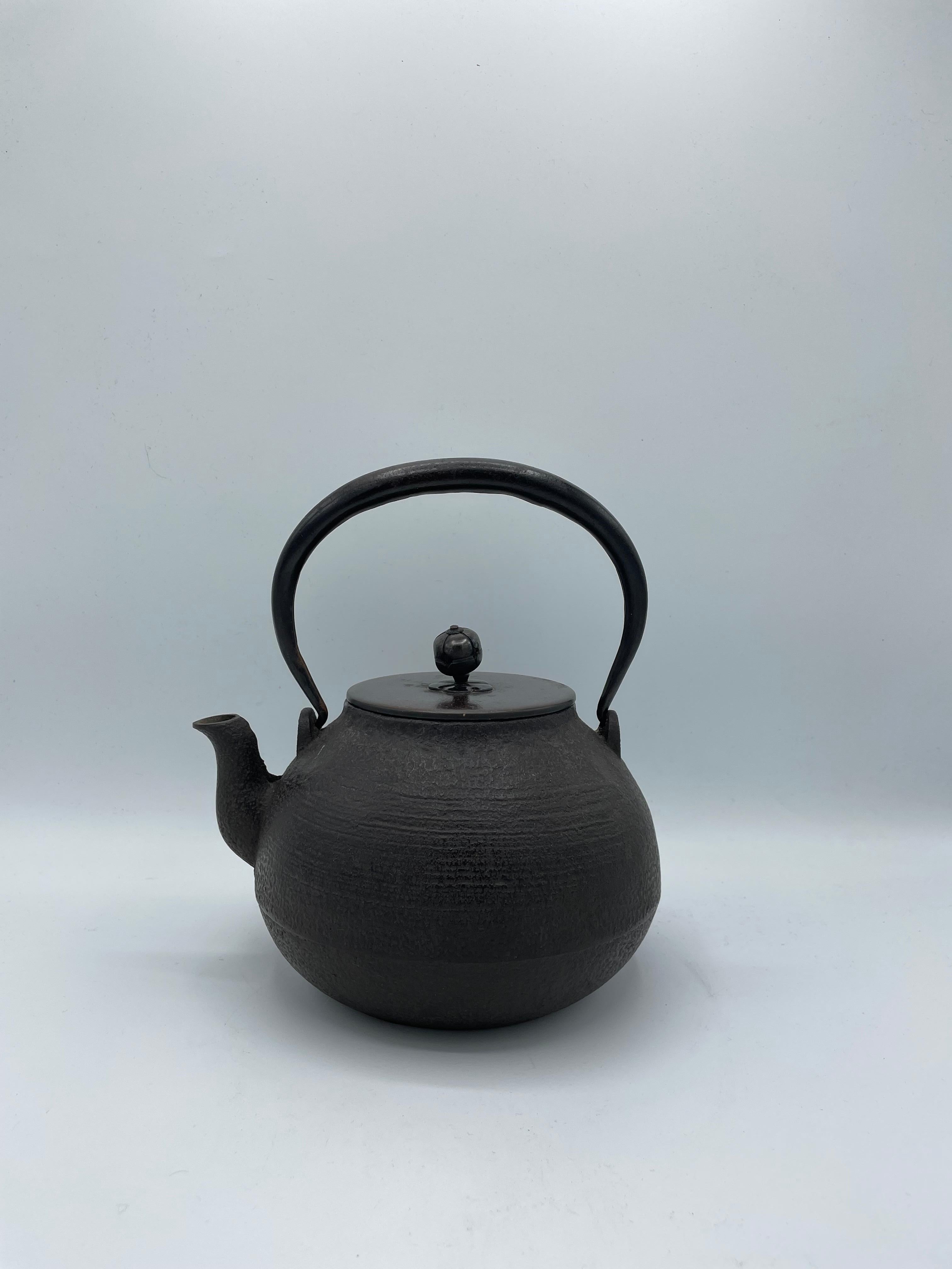 This kettle was made in 1930s, in Showa era. 
The iron kettles like this item are called 'Tetsubin' in Japan.
It can be put on the fire or an induction plate. Also we can use it as decoration.
Do not scratch the bottom of the kettle to leave the