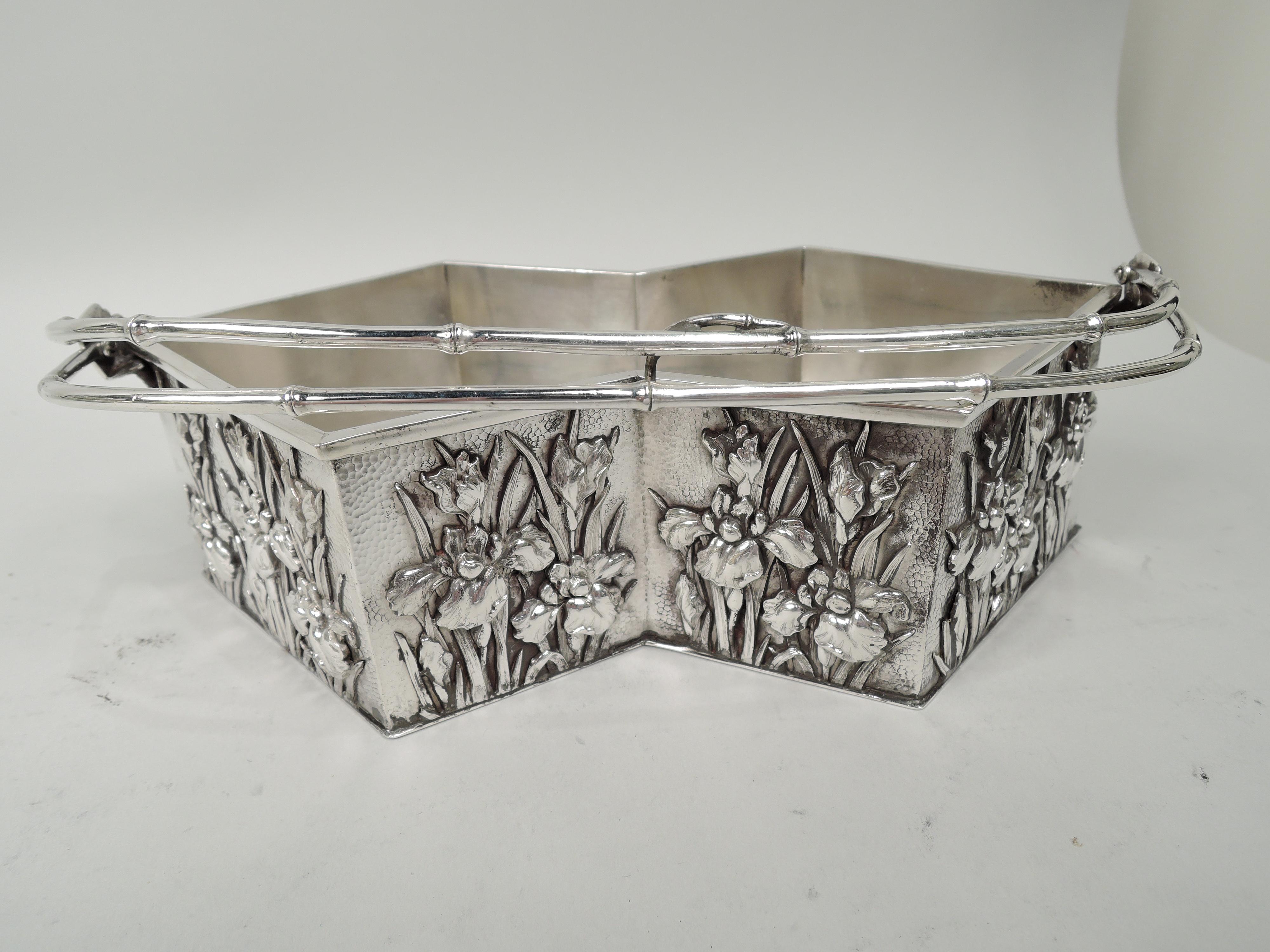 Japanese Meiji Art Nouveau silver basket, ca 1890. Faceted zigzag bowl with convex ends and concave sides, and double bamboo-style swing handle. Sides have applied iris flowers on stippled ground. Marked. Weight: 13 troy ounces.