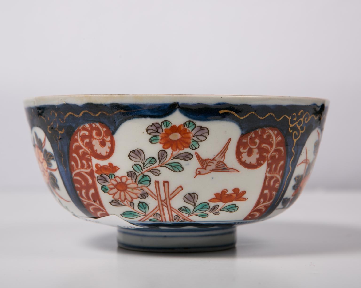 We are pleased to offer this small Imari Japanese porcelain bowl, dating from the Meiji era (1868-1912). The bowl is boldly painted with a deep underglaze blue and overglaze enameling of red. The well of the bowl features a hand painted landscape