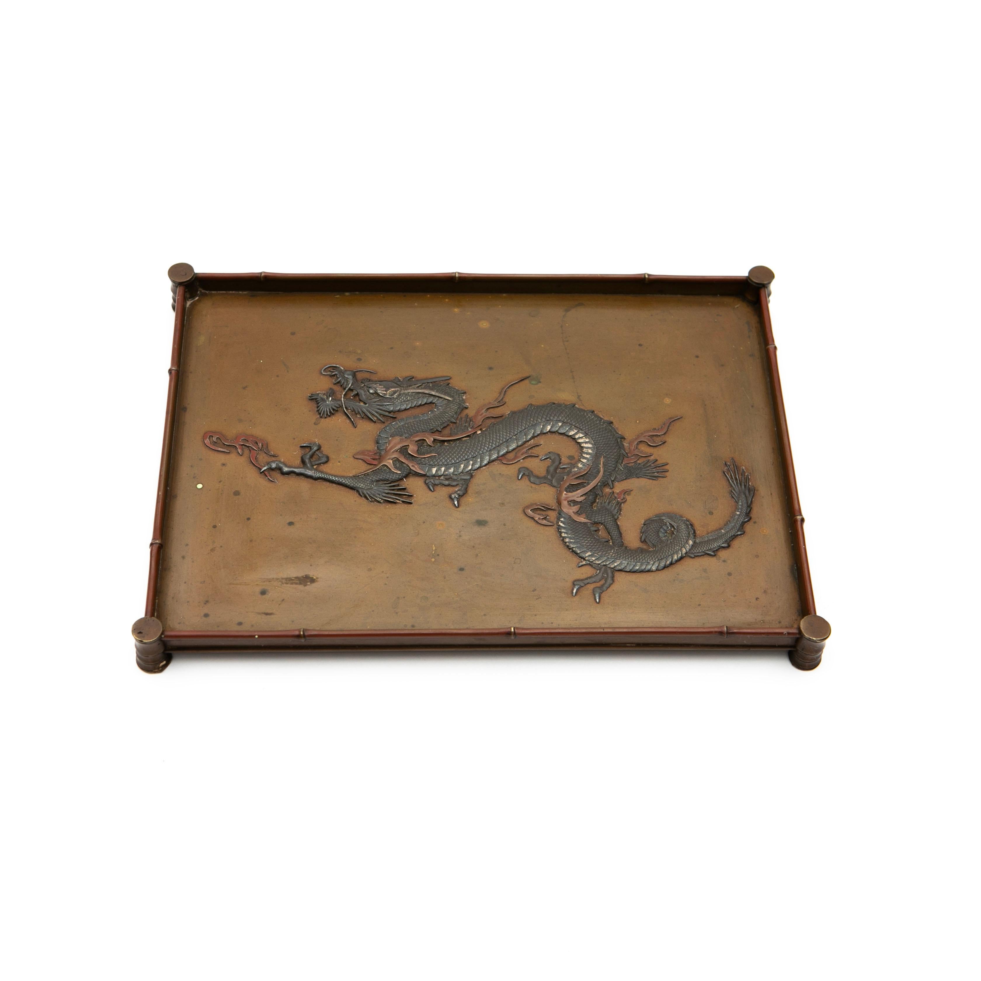 Bronze Tray from the Meiji Period (1868-1912), Japan.

A high-quality bronze tray featuring a finely detailed relief dragon motif in the center, expertly patinated in silvery and light brown-red tones of bronze, bringing depth and character to the