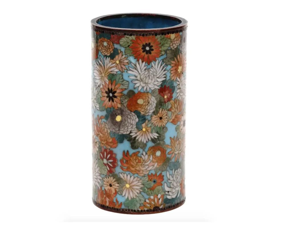 Antique Meiji Japanese Cloisonne Enamel Millefiori Brush Pot Goto School

An antique Japanese Meiji Era enamel brush pot. The cylindrical form pot is enameled with polychrome images of blossoming flowers, mostly chrysanthemum flowers made in the