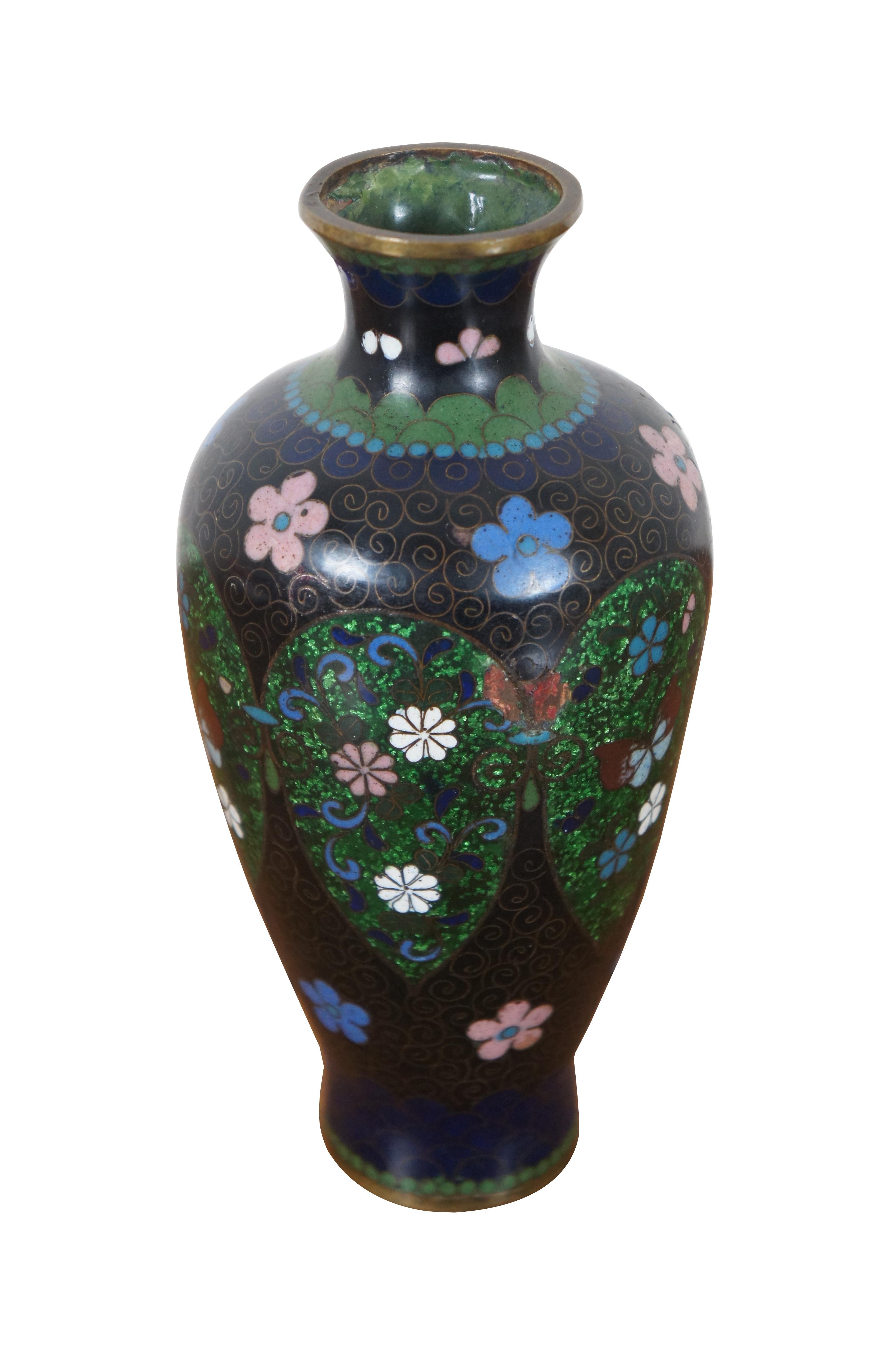 Antique Meiji era Japanese cloisonne bud vase in black with prominent pink, blue, and white flowers in and around tear drop shaped sections of green ginbari. Measure : 6