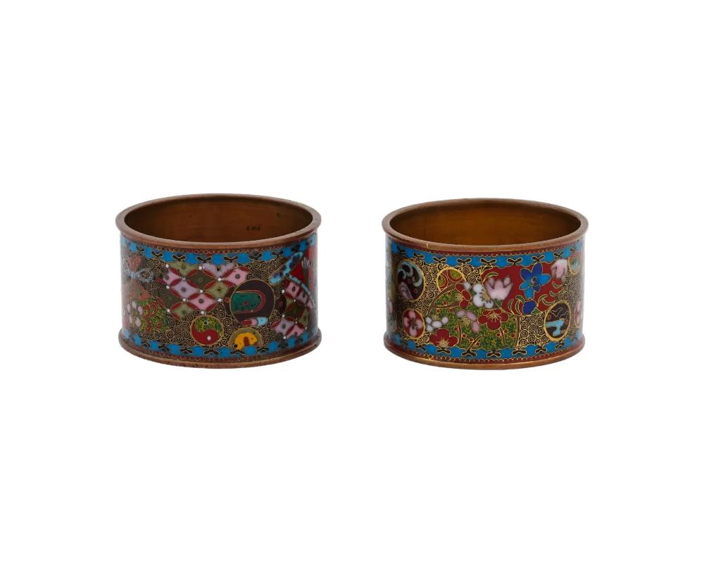 A pair of antique Japanese copper napkin rings with cloisonne enamel design. Late Meiji era, before 1912. Kyoto school. The items are decorated with polychrome floral and abstract ornaments. Collectible Oriental Asian Decor, Tableware And Serving