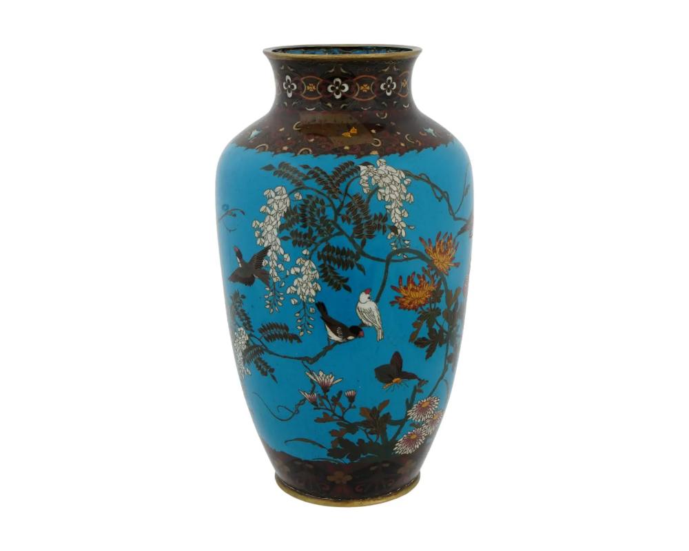 An antique Japanese copper vase with polychrome cloisonne enamel decor. Late Meiji period, before 1912. Baluster shape, flower brunches and birds decor against turquoise background. Floral ornaments on the neck and base. Collectible Oriental Asian