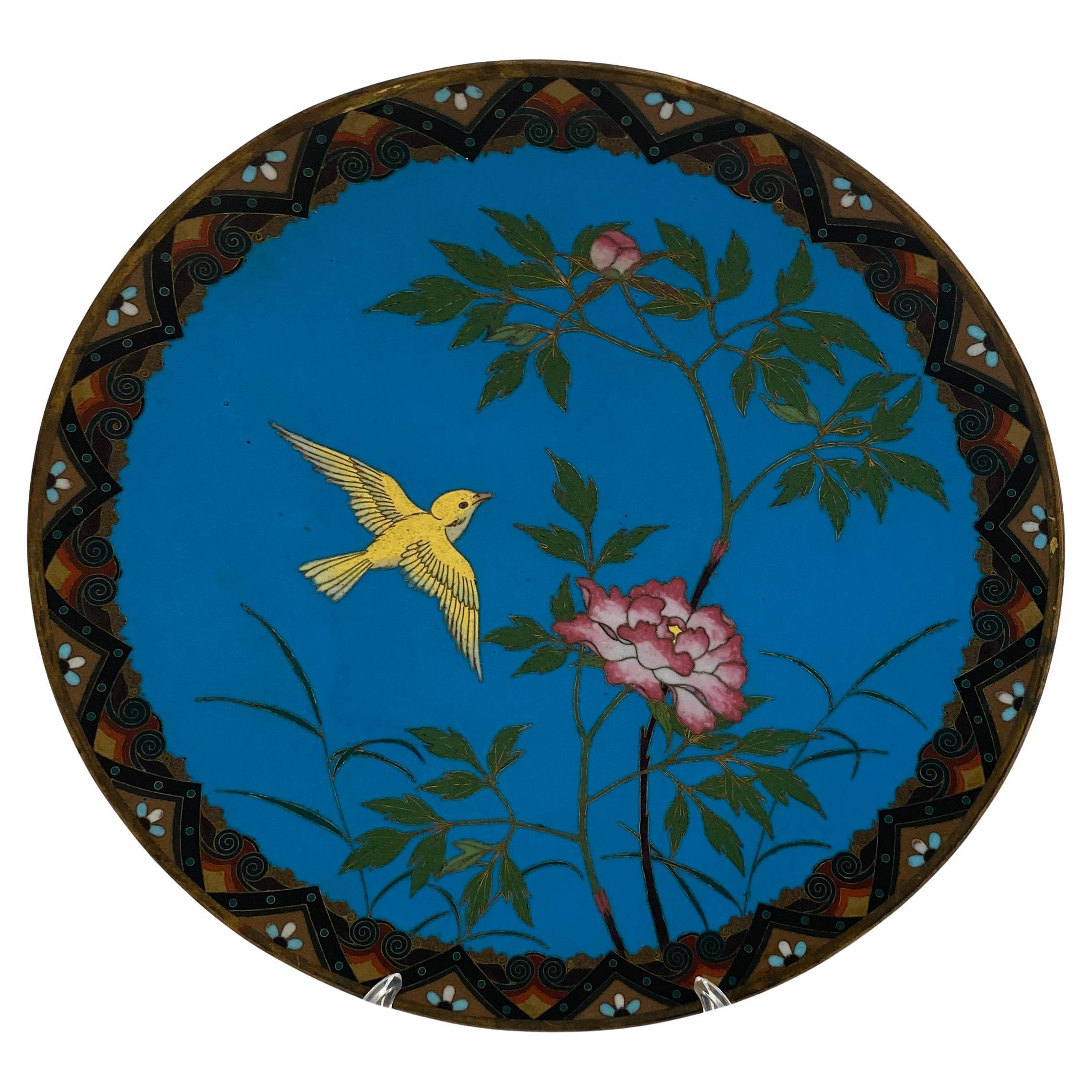 Antique Meiji Japanese Cloisonne Charger Plate 

A fine Japanese Meiji style charger, plate or dish. Hand crafted, this charger plate is adorned with a polychrome scene with a beautiful yellow bird and a rose. There is also a blossoming flower and