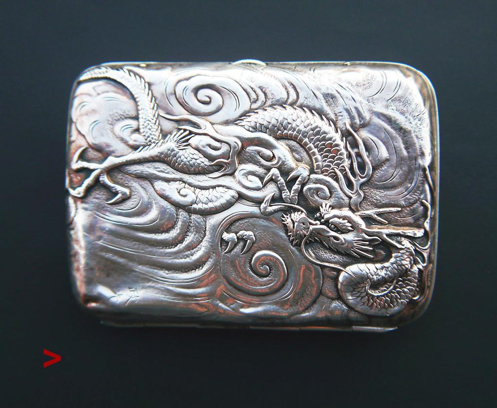 Late 19th-early 20th century Meiji period hand-made Japanese cigarette case in fine Silver with relief decorations of Dragons flying in the clouds. These dragons were hand-chased on sheets of Silver with great precision and attention to the smallest