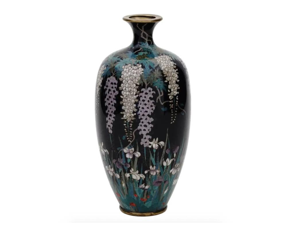 High Quality Antique Meiji Japanese Cloisonne Enamel Silver Wire Vase Blossoming Wisteria and Iris's

An antique Japanese, late Meiji period, enamel over brass vase. The vase has an amphora shaped body and a fluted neck. The ware is enameled with a
