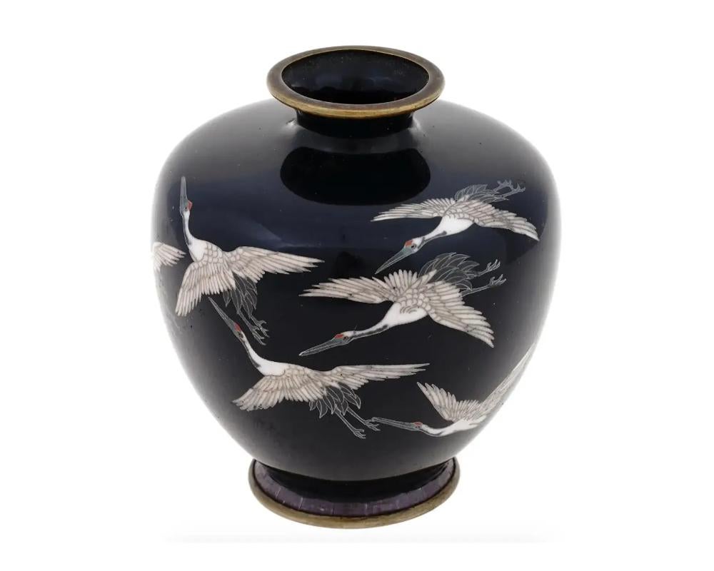 Antique Meiji Japanese Cloisonne Enamel Vase with Flying Cranes Hayashi School

An antique Japanese, late Meiji period, enamel . The vase has a sphere shaped body and a wide fluted neck. The ware is enameled with a polychrome image of cranes on the