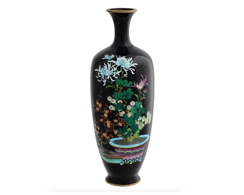 An antique Japanese copper vase with polychrome cloisonne enamel decor. Late Meiji period, before 1912. Baluster shape, black body with ginbari decor representing a chrysanthemum flower in a pot. Katakana letter Ho mark on the bottom. Ginbari is a