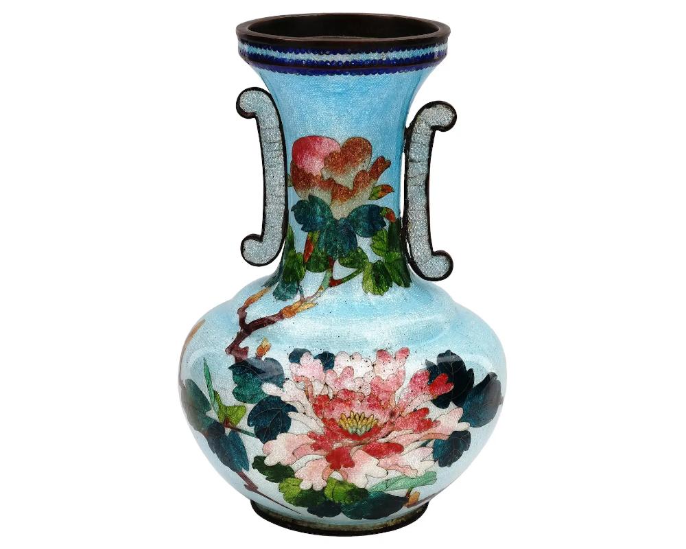 An antique Japanese copper vase with polychrome ginbari cloisonne enamel decor. Late Meiji period,

Squat round shape, long neck and decorative side handles. Blue body with pink and green peony flower motif.

Ginbari is a Japanese cloisonne