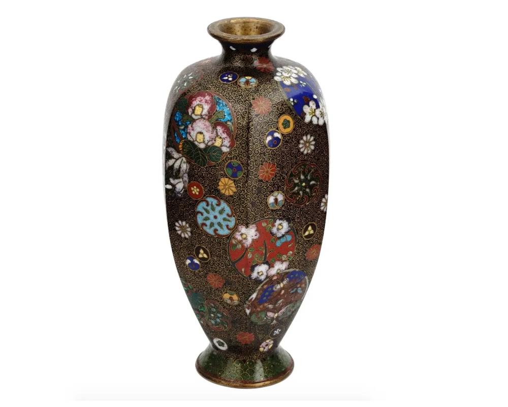 An antique Japanese copper vase with cloisonne enamel design. Late Meiji period, before 1912. The vase has a faceted body with pronounced neck and base. The item is richly decorated with floral and geometrical ornaments. Nagoya school. Collectible
