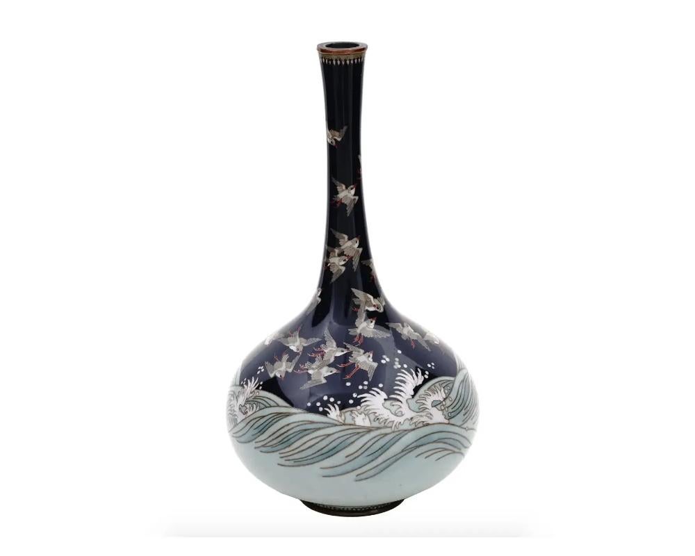 Antique Meiji Japanese Cloisonne Enamel Silver Wire Vase with Sparrow's over Waves
An antique Japanese, late Meiji period, silver wire enamel vase.
The vase has a sphere shaped body and a tall fluted neck.
The ware is enameled with a polychrome