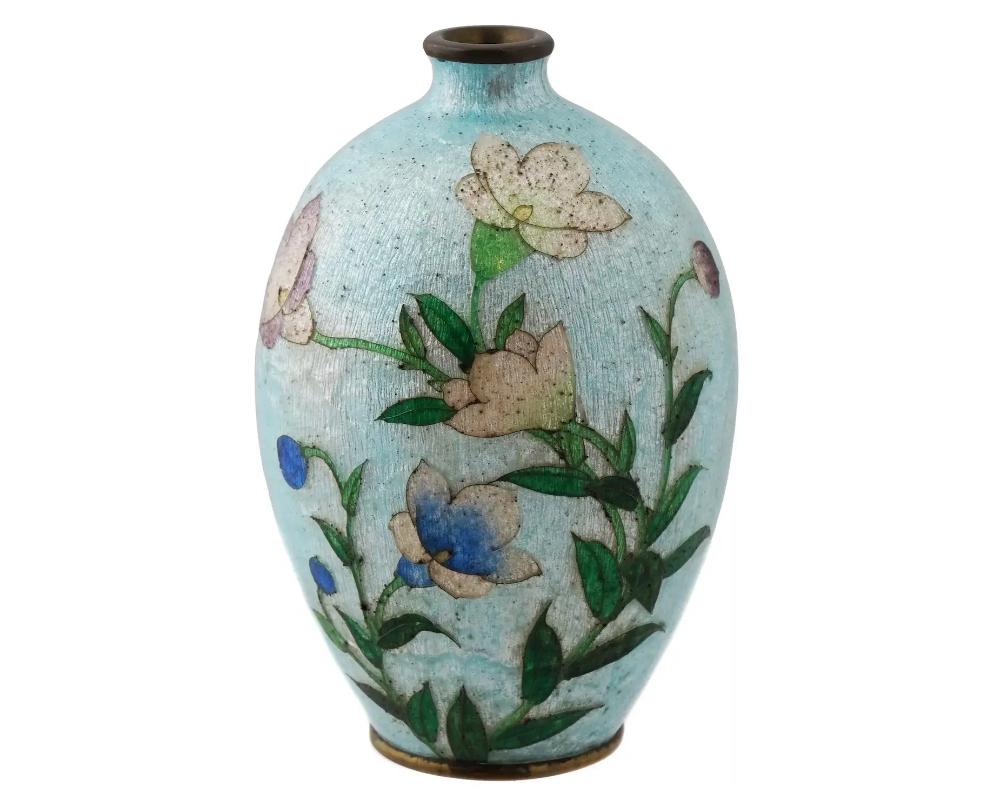 An antique Japanese, late Meiji era, Ginbari enamel over copper vase. The globular shaped vase is enameled with a polychrome image of blossoming Bluebells flowers on the light blue ground made in the Ginbari Cloisonne technique. Ginbari is a