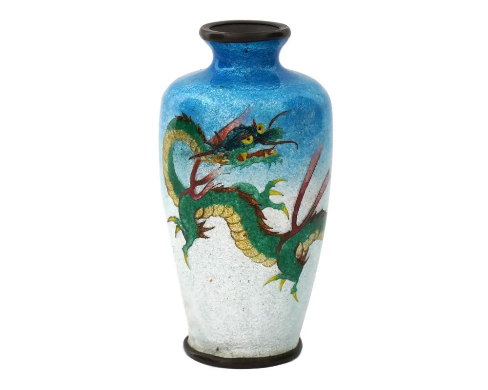 An antique Japanese, late Meiji era, Ginbari enamel over copper vase. The urn shaped vase is enameled with a polychrome image of a dragon on the light blue and white ground made in the Ginbari Cloisonne technique. Ginbari is a Japanese cloisonne