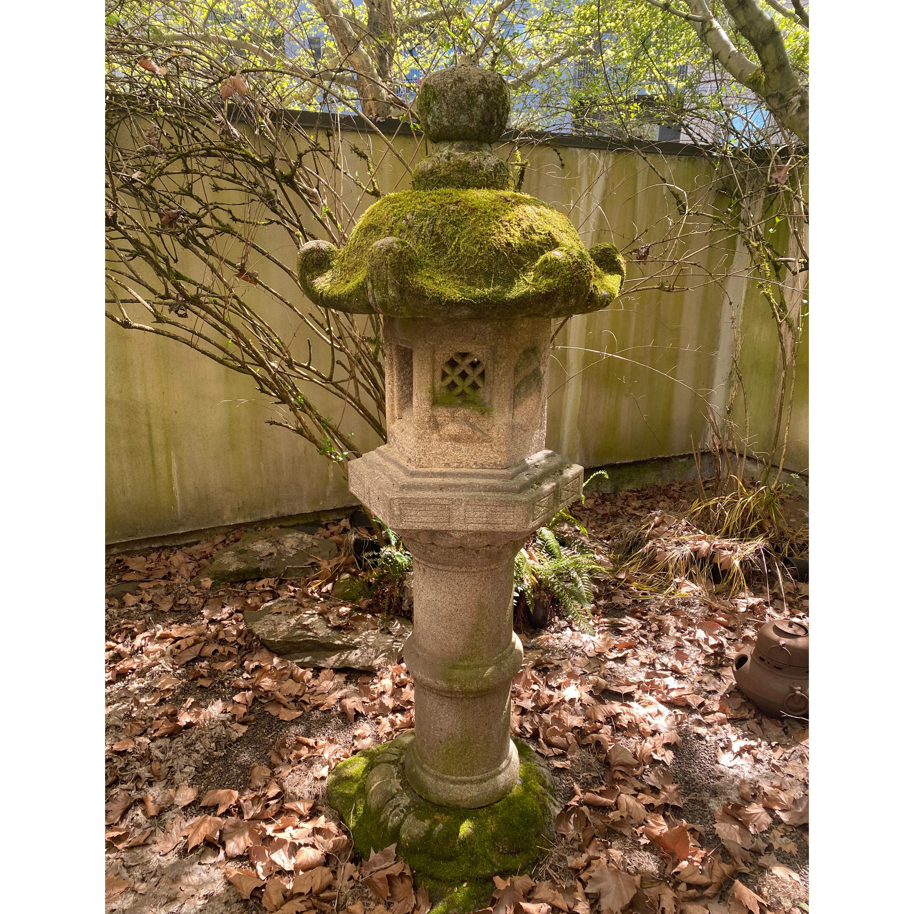 Antique Japanese Meiji period fine tall Kasuga granite stone pedestal garden lantern, circa 1800.
This well proportioned carved stone lantern is fashioned in six parts, with a classic lotus Kasuga and finial Hohju, light chamber Hibukuro, turned