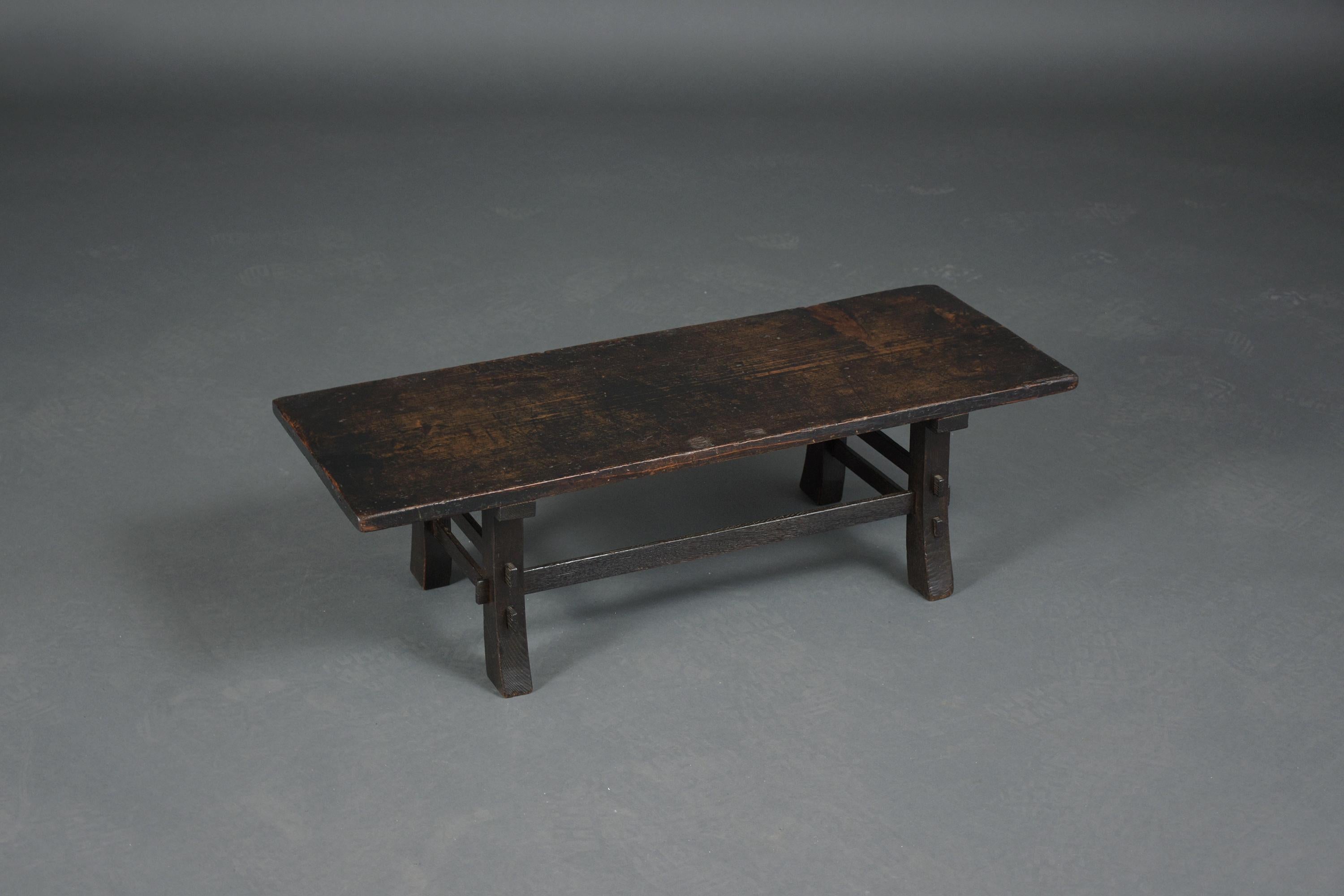 An extraordinary 19th-century Japanese low table beautifully crafted out of elmwood and has been professionally restored by our craftsmen. This fabulous piece features an original dark brown color newly waxed and polished developing a beautiful