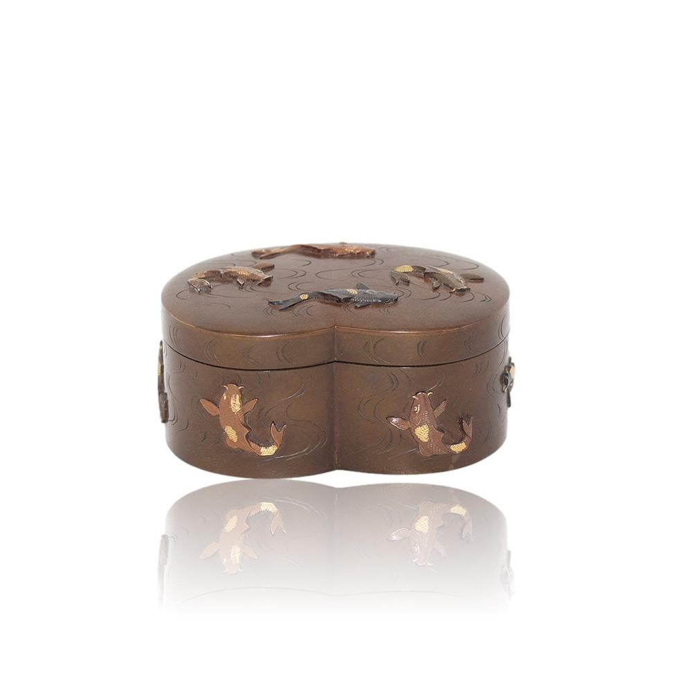 Meiji Period (1868-1912)

From our Japanese collection, we are delighted to offer this Japanese Meiji Period Bronze Mixed Metals Box. The Japanese Meiji Period Bronze Box formed in a kidney shape and decorated to the exterior with naturalistic