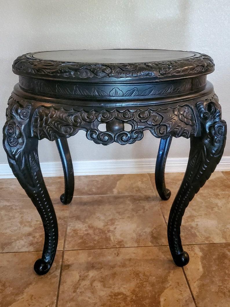 A magnificent antique Japanese powerfully carved center table with dragons from the Meiji period. 

The growth of urban centers and spread of wealth during the Meiji Restoration period in Japan ushered in an era that reveled in the aesthetic