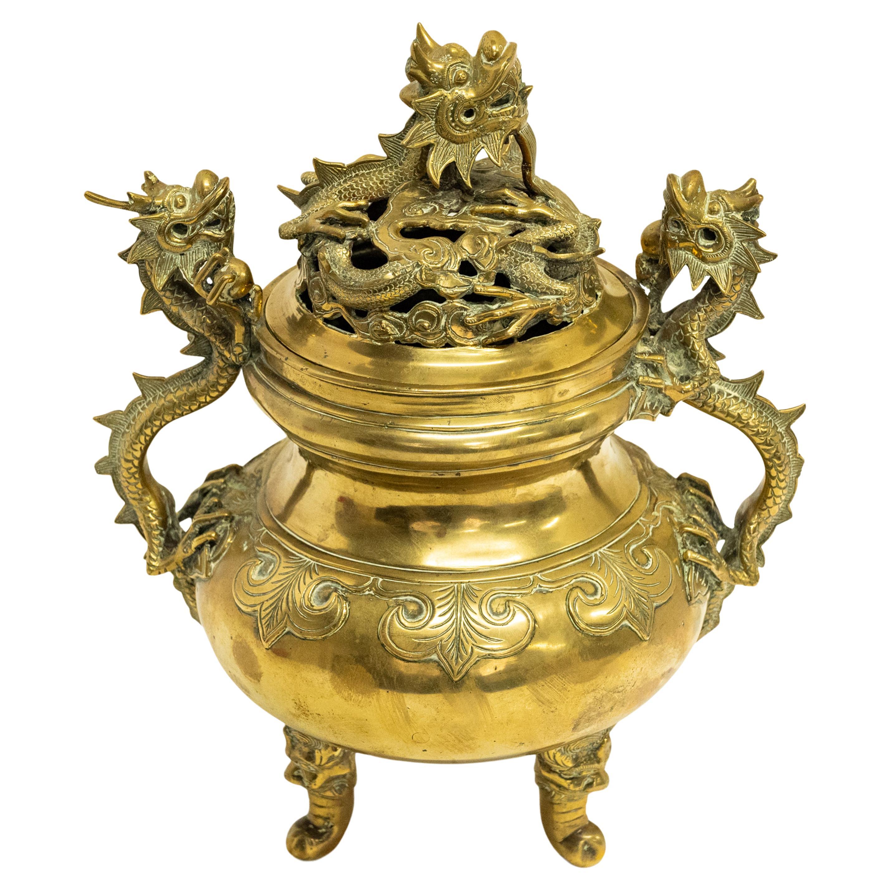 A good antique Japanese gilt bronze Meiji period dragon koro, incense burner, circa 1880.
The koro having a nesting dragon to the lid, the three toed dragon seated on a bed of clouds, the handles are also formed as dragons each holding a pearl in