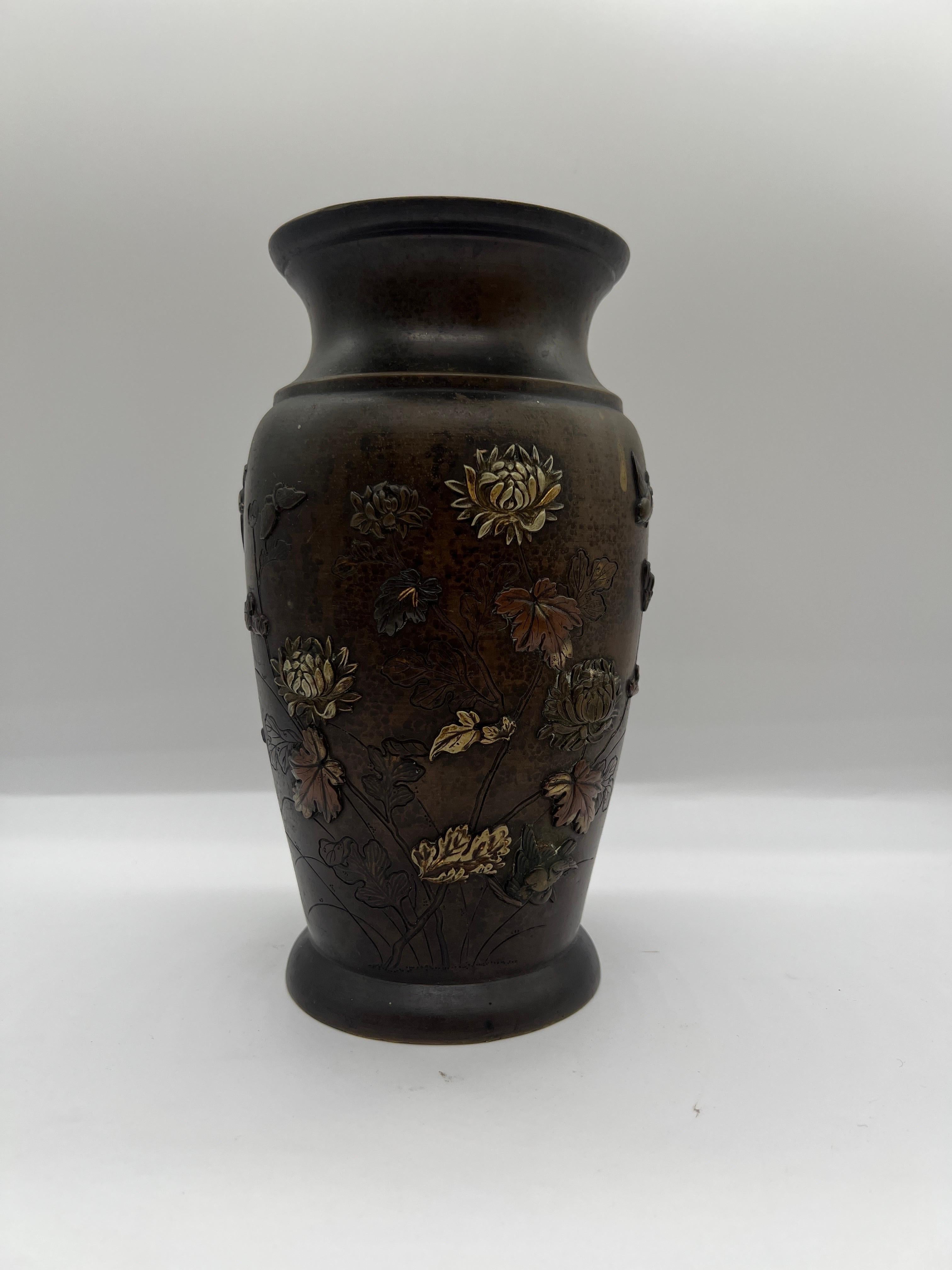 Japanese, Meiji Period.

An antique bronze vase constructed in bronze. The vase features several traditional designs including lotus blossoms, birds in flight and other floral detailing. Different metal materials have been used for this vase as