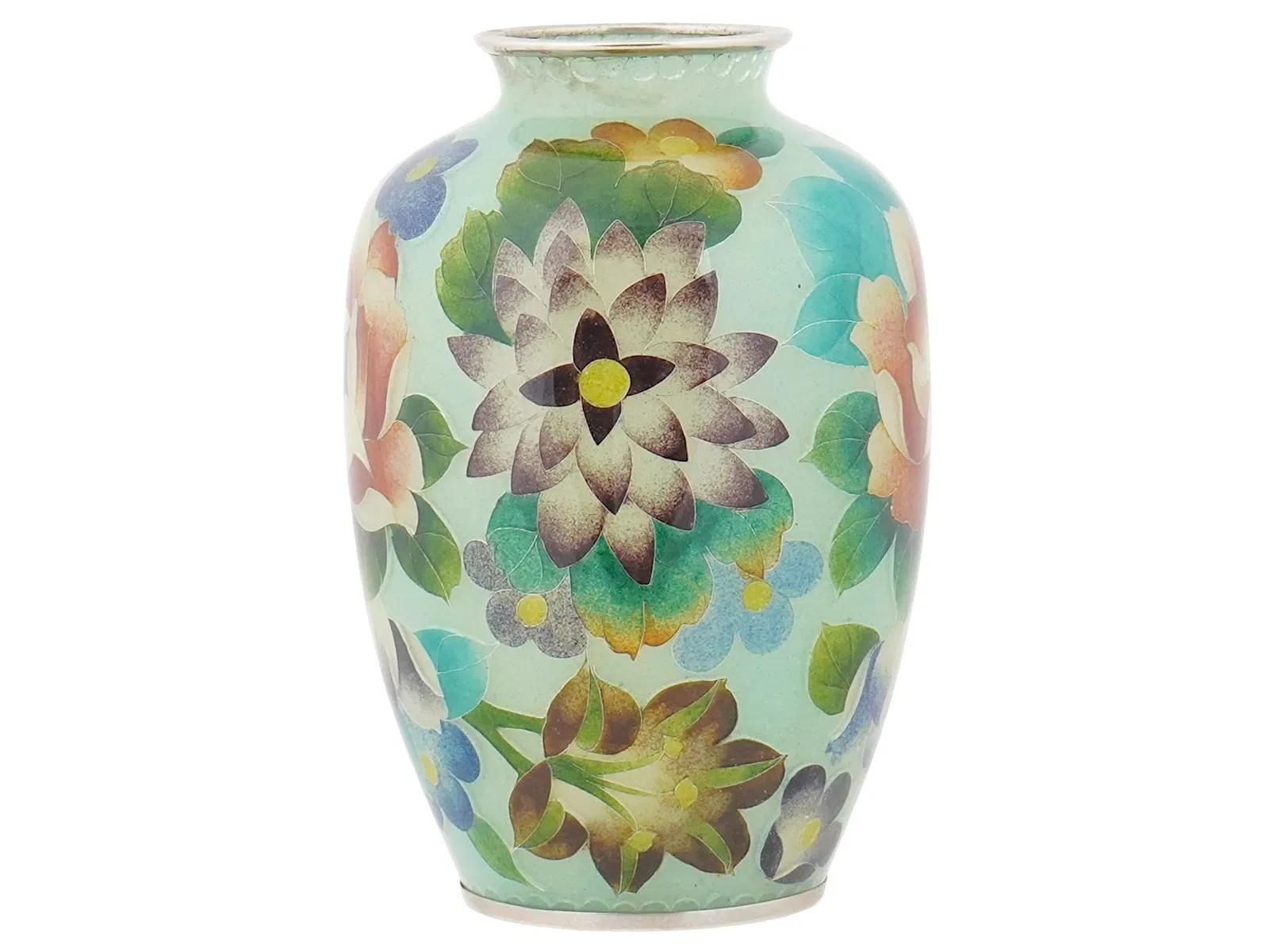 An antique Japanese glass vase executed in the Shotai Shippo technique, a Japanese type of plique-a-jour enamel. Late Meiji era, before 1912. Stylized floating chrysanthemum blossoms design. The neck and neck are made of silvered metal. Unmatked.