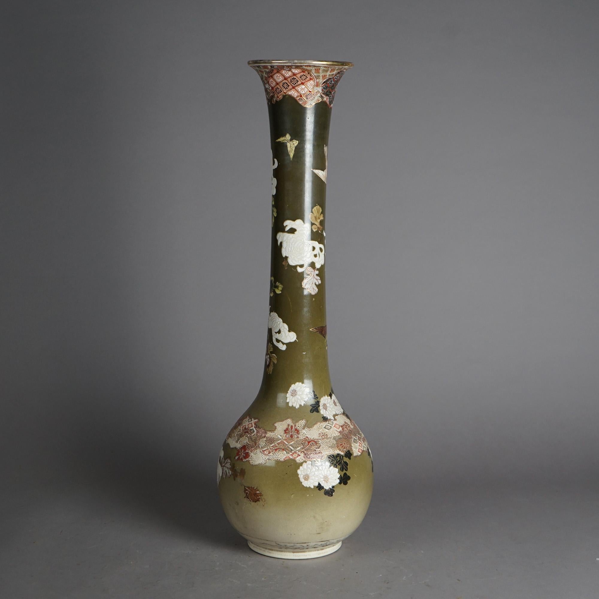 An antique Japanese Meiji Satsuma tall vase offers porcelain construction with hand painted and gilt garden scene having flowers and birds, c1900

Measures- 26.5''H x 8.25''W x 8.25''D