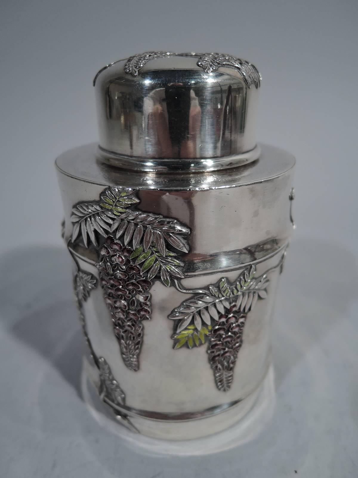 Japanese Meiji silver and enamel tea caddy, circa 1900. Drum form with stippled top, short neck, and snug-fitting cover. Applied wisteria heightened with green, purple, and white enamel. A beautiful piece with practical use: Interior plug keeps