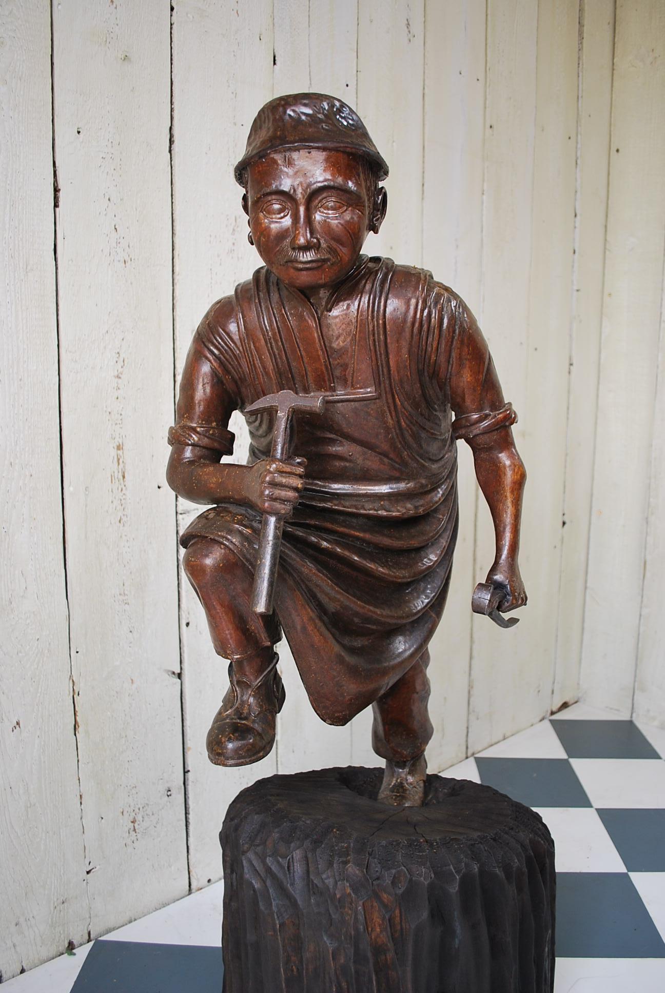 This is a rare and unusual antique Meiji period Japanese carved wood shop display figure of a craftsman with tools. Standing on a later base which detaches as seen in the photograph.