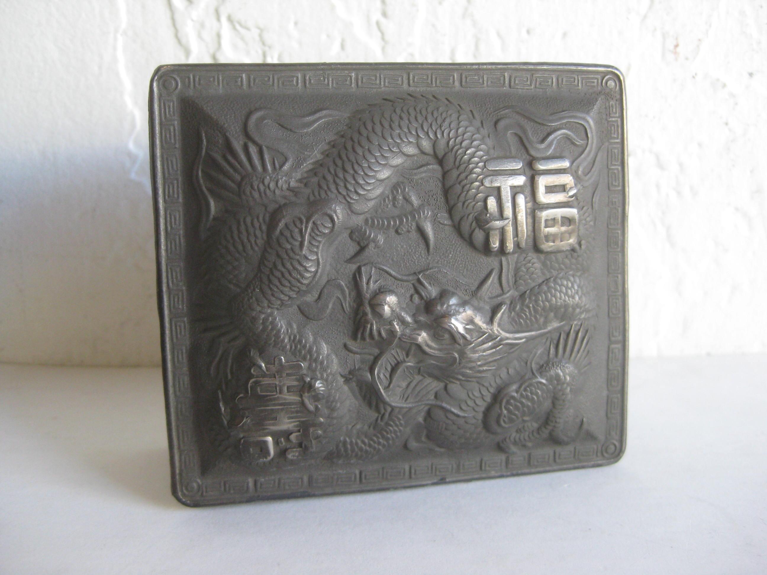Great antique Japanese metal relief stash/cigarette box. Has a dragon design on the lid and then on the sides of the box. Marked 