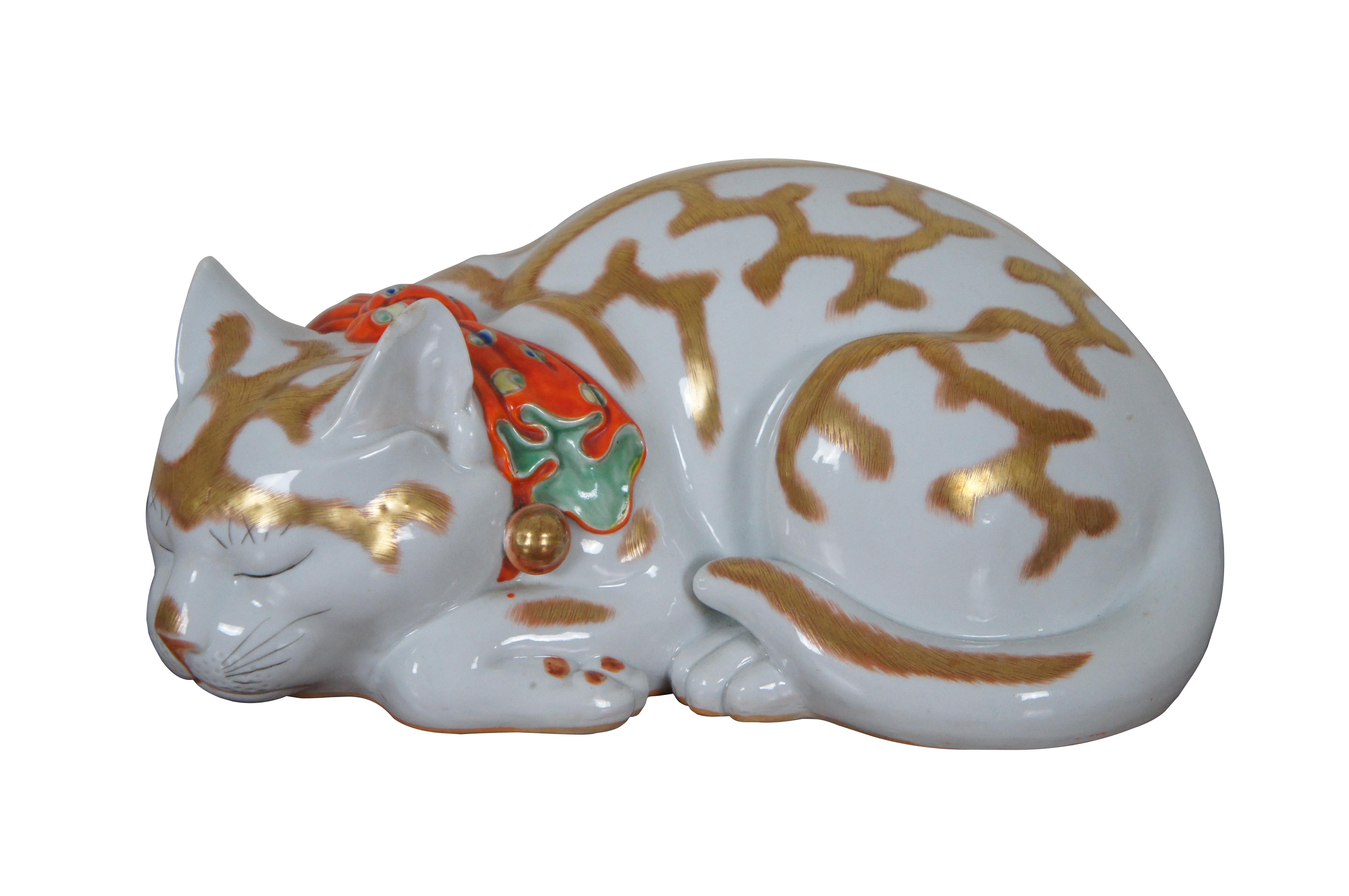 Antique porcelain Imari sleeping cat and kitten figurines featuring gold accents and red bandana with bells.

Dimensions:
Cat - 12” x 8.5” x 5.5” / Kitten - 7” x 5” x 3.25” (Width x Depth x Height)