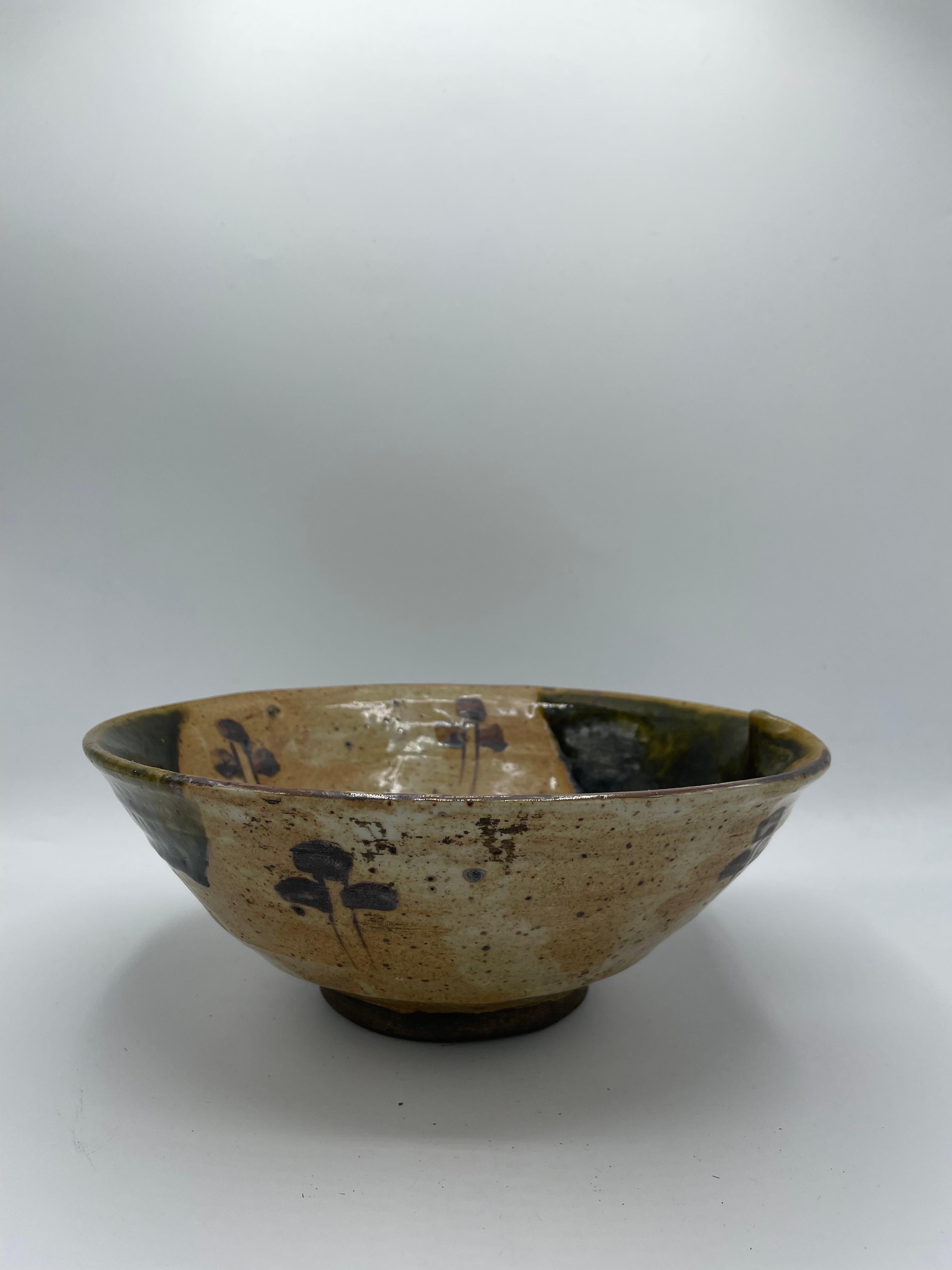 This is an antique porcelain serving bowl.
It is made with Oribe ware technique in Japan. This bowl was made in Edo era around 1850.

Oribe ware (Oribe-yaki) is a style of Japanese pottery that first appeared in the sixteenth century. It is a type