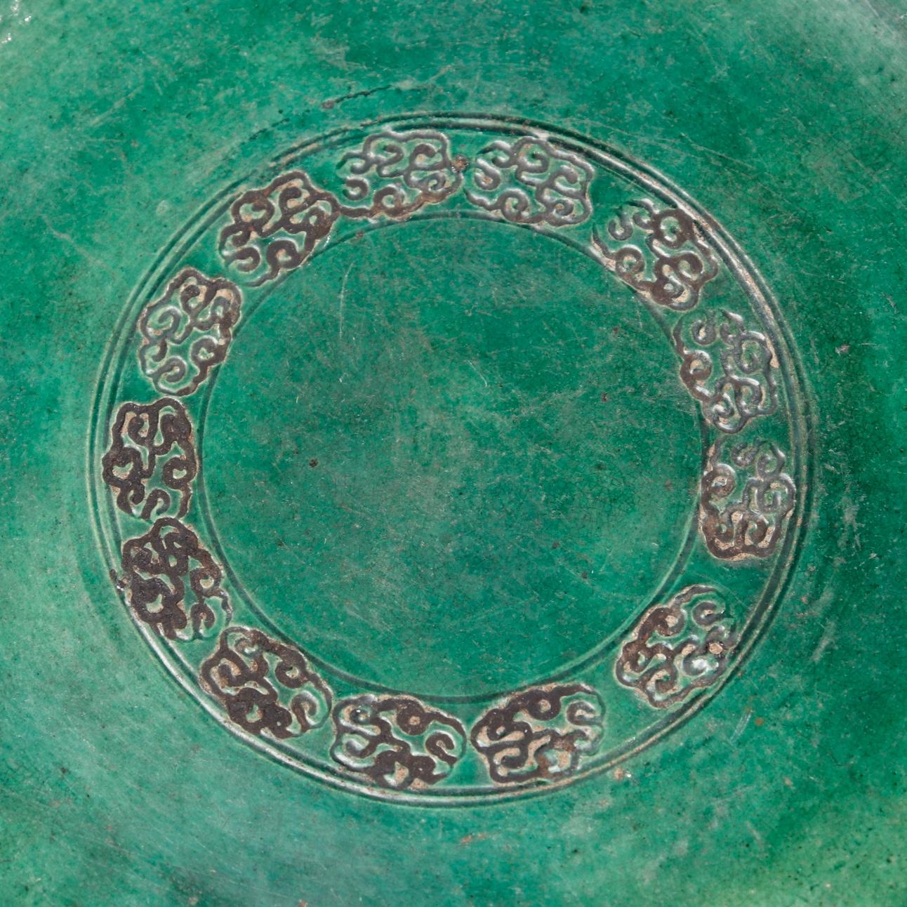 apanese Oribe style ceramic Abura-zara, an oil plate used to catch the drippings from a suspended oil dish in a lantern, simple flat circular form with slightly raised beaded edge and impressed circular cloud pattern on the top surface, unusual