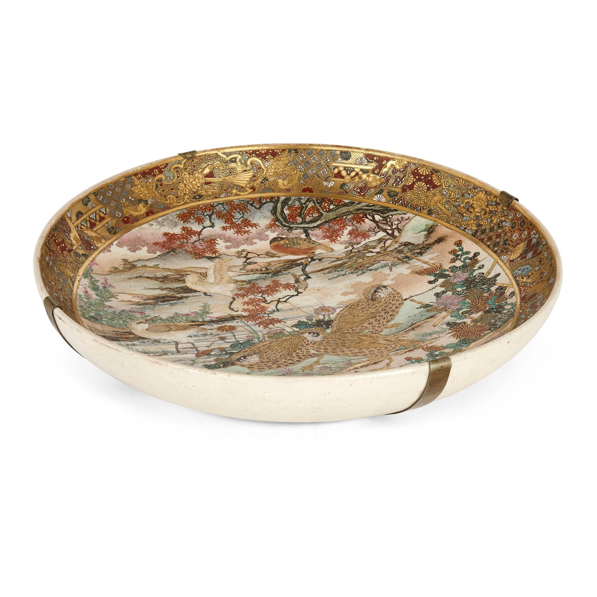 Antique Japanese parcel-gilt porcelain dish
Japanese, late 19th century
Measures: Height 7.5cm, diameter 37cm

This fine porcelain dish is a superb piece Satsuma ware from the Meiji period: Satsuma ware being a Japanese style designed to appeal