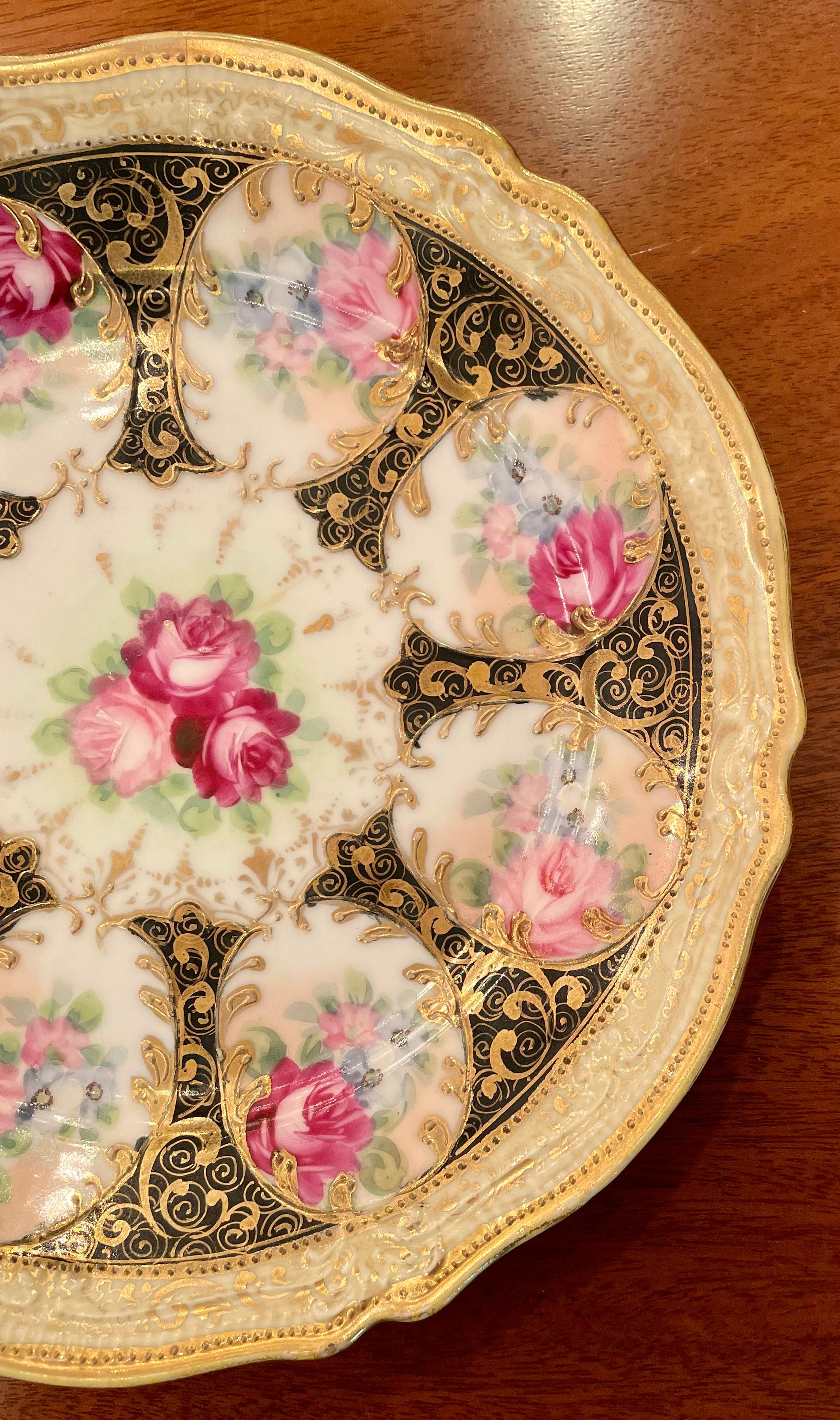 Antique Japanese porcelain plate, hand-decorated gold, ivory & black with florals, Circa 1900.