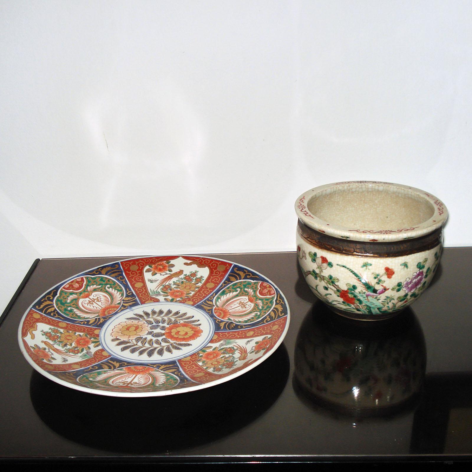 Circa 19th century Imari charger with scrolled stand. The charger plate features six various illustrations of flowers, birds, and butterflies framing a center medallion of flowers.
Measure: Diameter 37 cm.