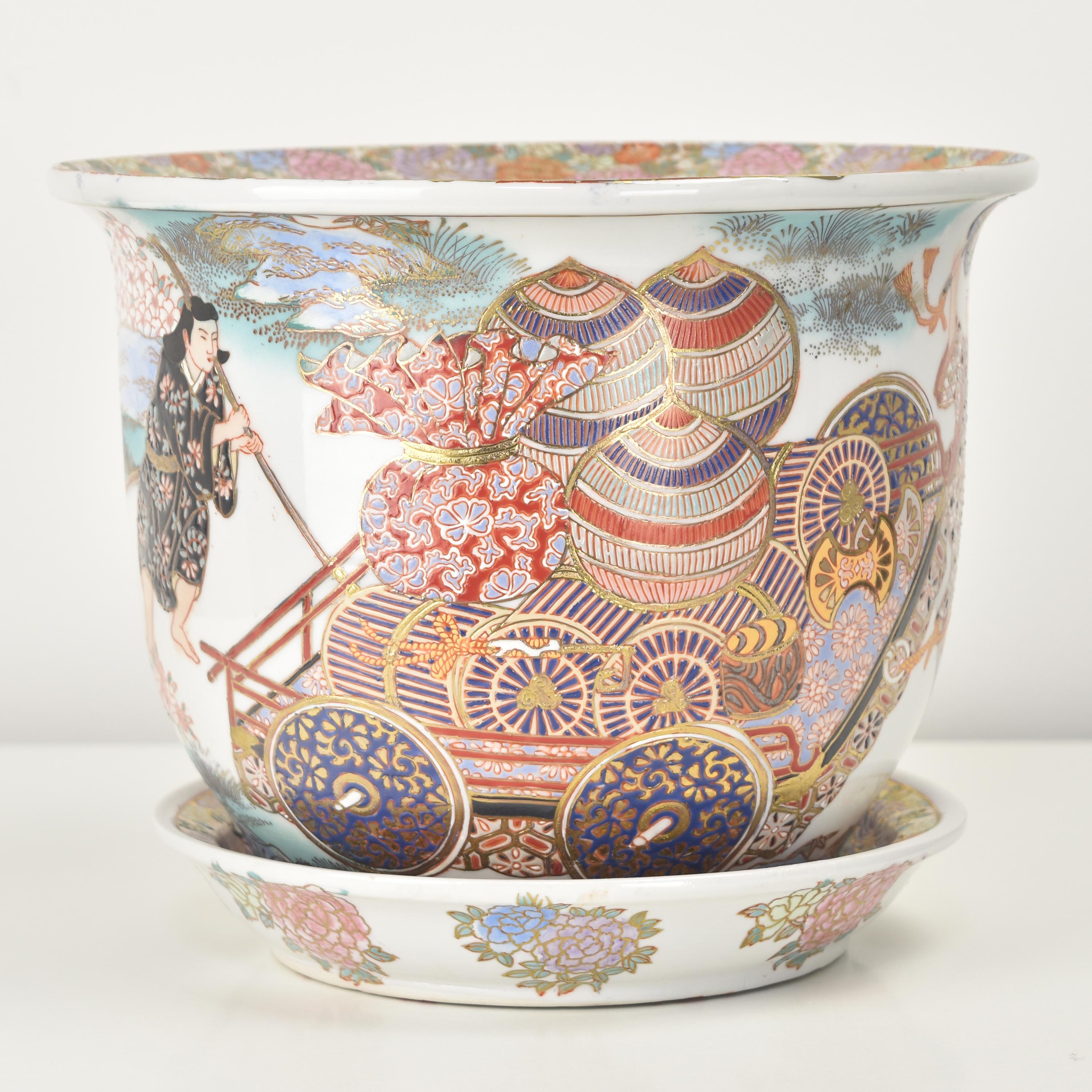 Cette élégante jardinière en porcelaine japonaise et sa soucoupe assortie sont magnifiquement peintes à la main avec des scènes complexes et colorées représentant des personnages et des paysages japonais traditionnels. La finesse des détails