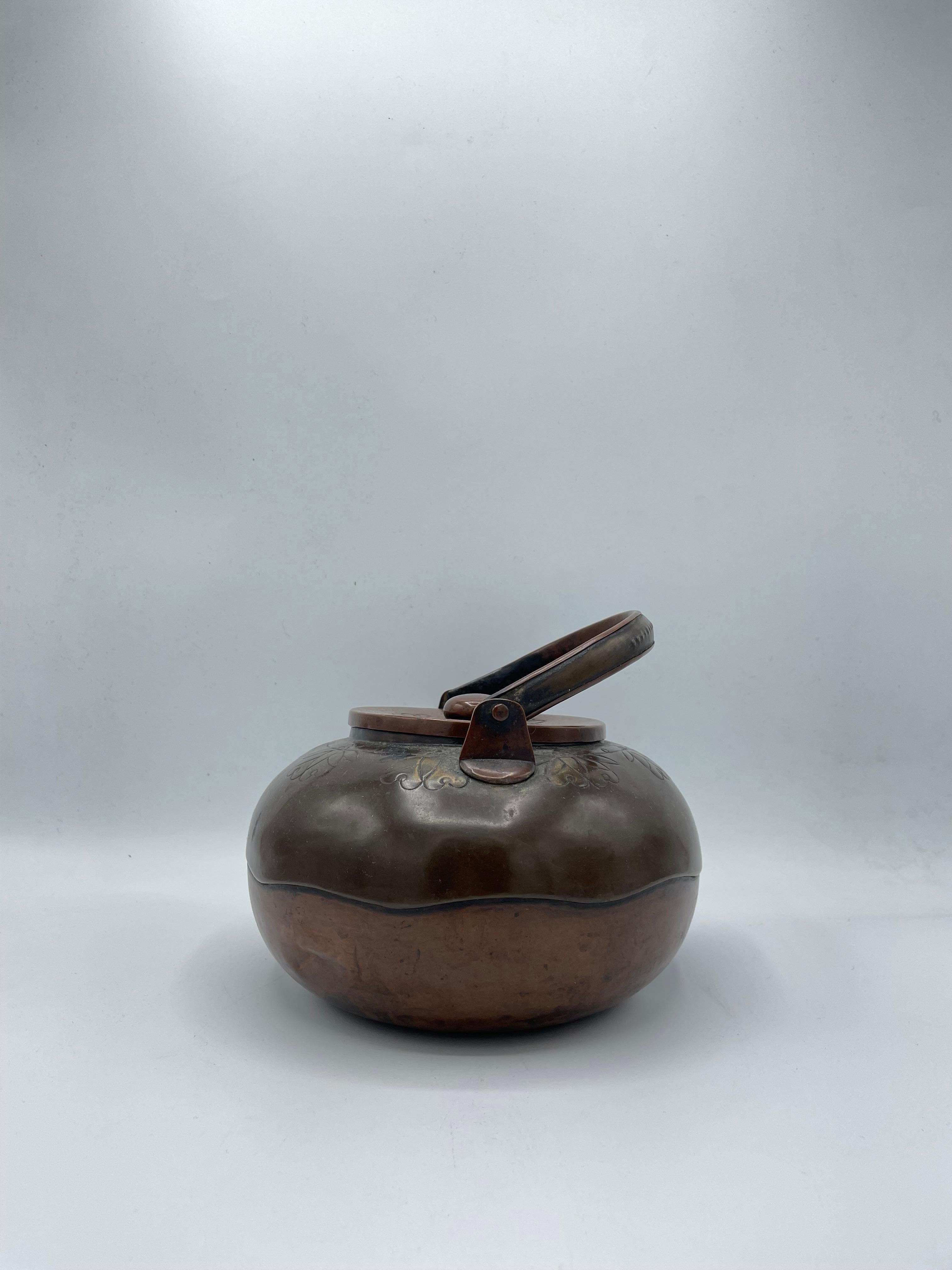 This is an antique pitcher for tea ceremony made in Japan around 1920s (Taisho era). And made with Copper. 

This kind of pitchers are called 'Mizusashi' in Japanese. A mizusashi is a tool used to hold water needed for the tea ceremony. It is used
