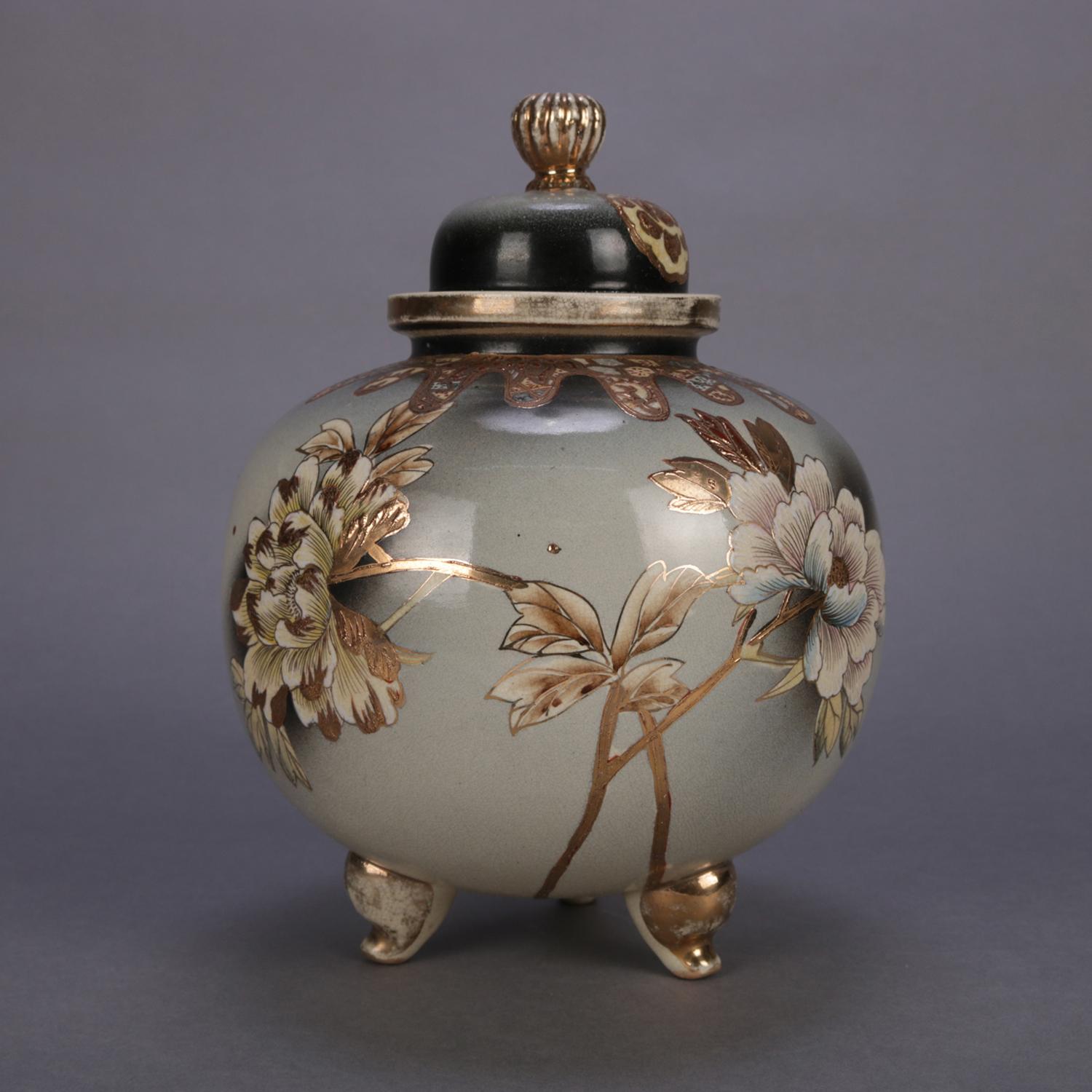 An antique Japanese Satsuma porcelain jar features ball form and hand painted and gilt floral decoration, lid with reeded finial and seated on gilt scroll form feet, chop mark signed on base, 20th century

Measures: 12