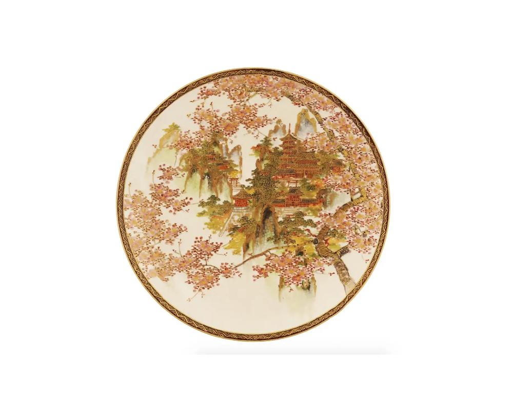 An antique Japanese Satsuma porcelain plate. The plate is decorated with hand-painted pagoda and cherry blossom designs. Marked to the back with the artist's seal. Circa in the early 20th century. Antique Japanese Porcelain