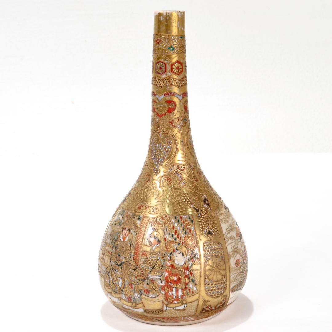 A fine antique Japanese Satsuma pottery vase.

In the form of a bud vase with a round base and narrow, tapered neck.

Decorated throughout with gilding & enamel complete with extensive embossed textures and patterns.

There are three cartouches to