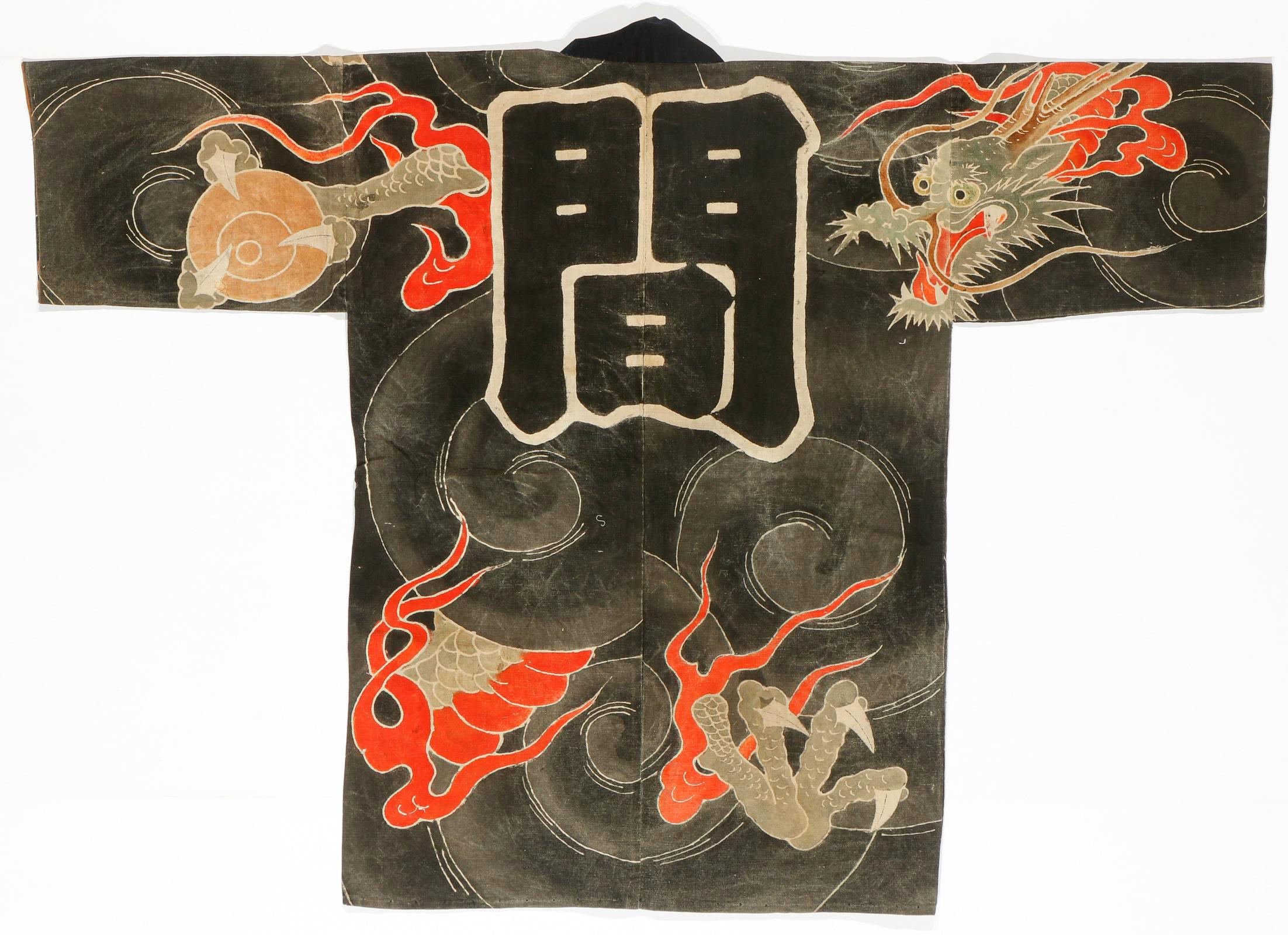 A Japanese Shirushi-Banten (Fireman's Coat) circa 19th century of Edo Period. The robe was made from a heavy cotton fiber and decorated with a dramatic dragon in the dark cloud scheme using Tsutsugaki, a free-hand resist dye method. A dragon with