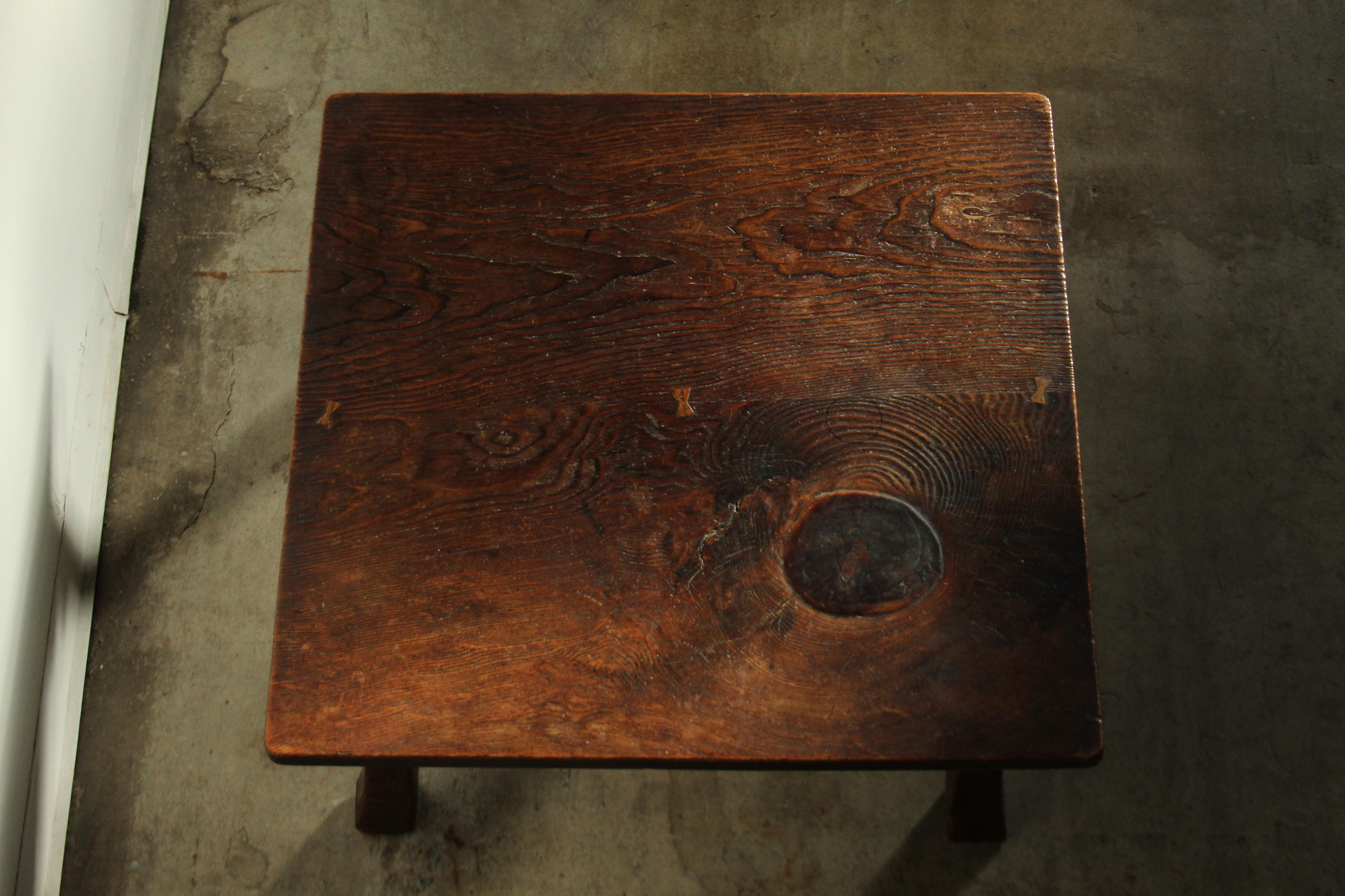 An extraordinary 19th century antique Japanese low table constructed from an incredible and substantial, old growth cedar plank, with 4 out swept legs. This piece was made in Japan, likely in the late 1800s to 1900. 
The table is finished with a
