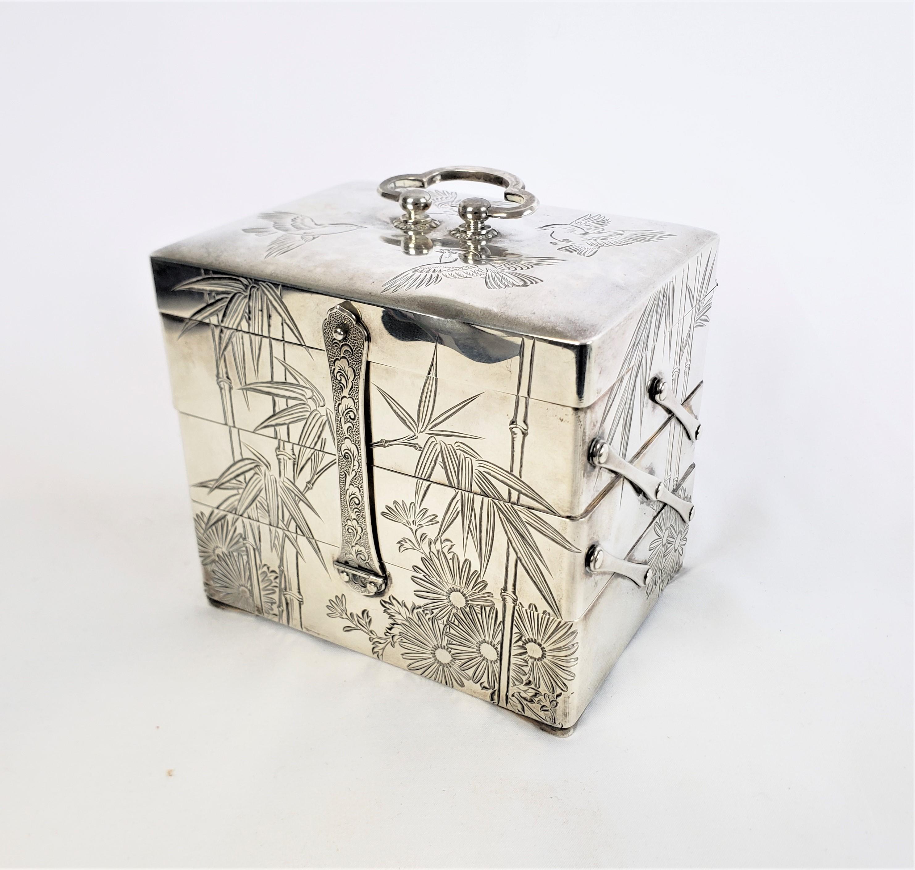 This antique jewelry box is unsigned, but presumed to have originated from Japan and date to approximately 1920 and done in the period Japanese Export style. The box is composed of silver over a wood frame with a latch on the front and back and