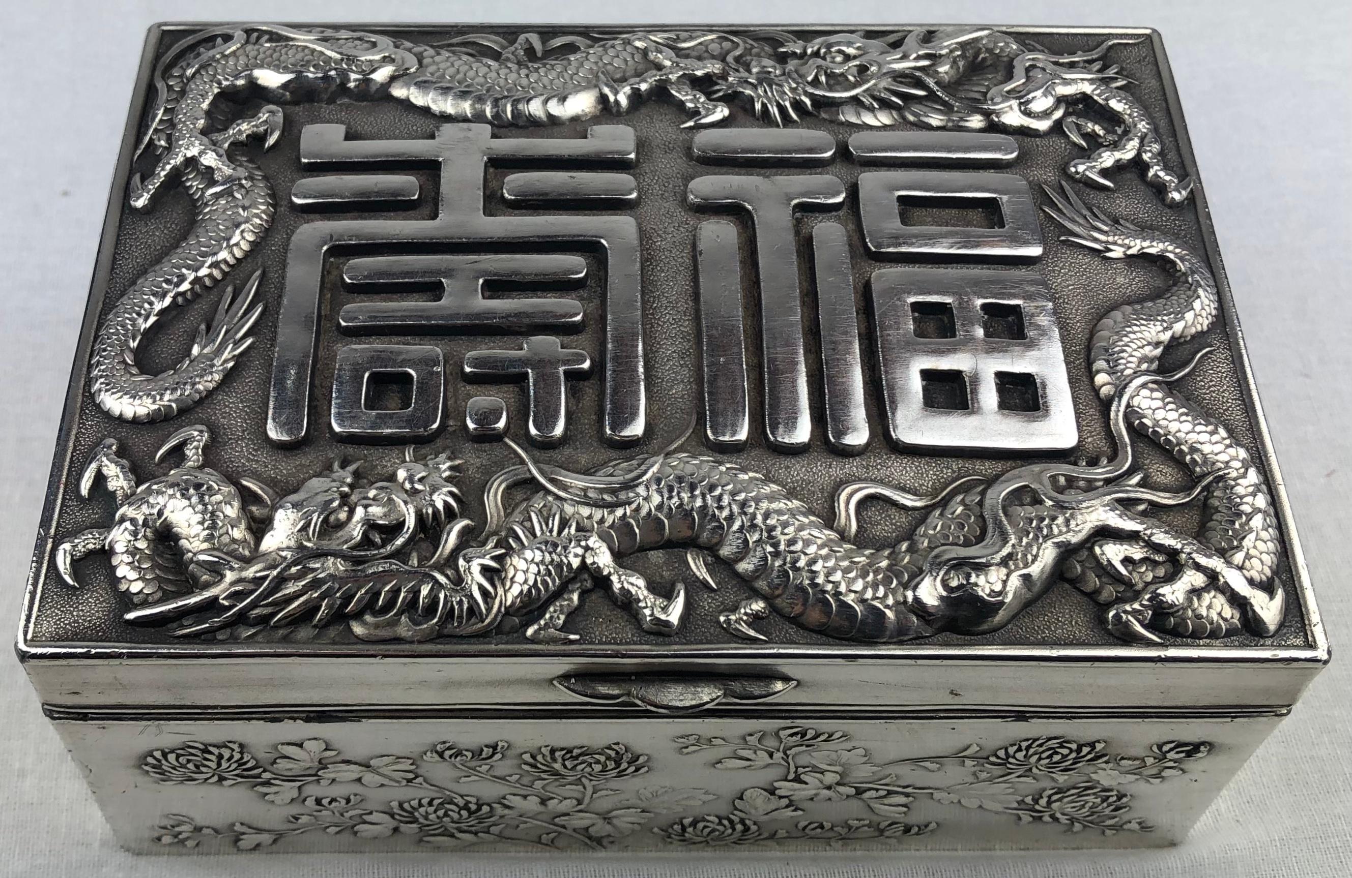 A stunning antique Japanese silver cigar, jewelry or keepsake box intricately designed and handcrafted, circa 1900s. 

Double skinned body, sides and lid are embossed in high-relief with water dragons and applied with flowing whiskers on hand