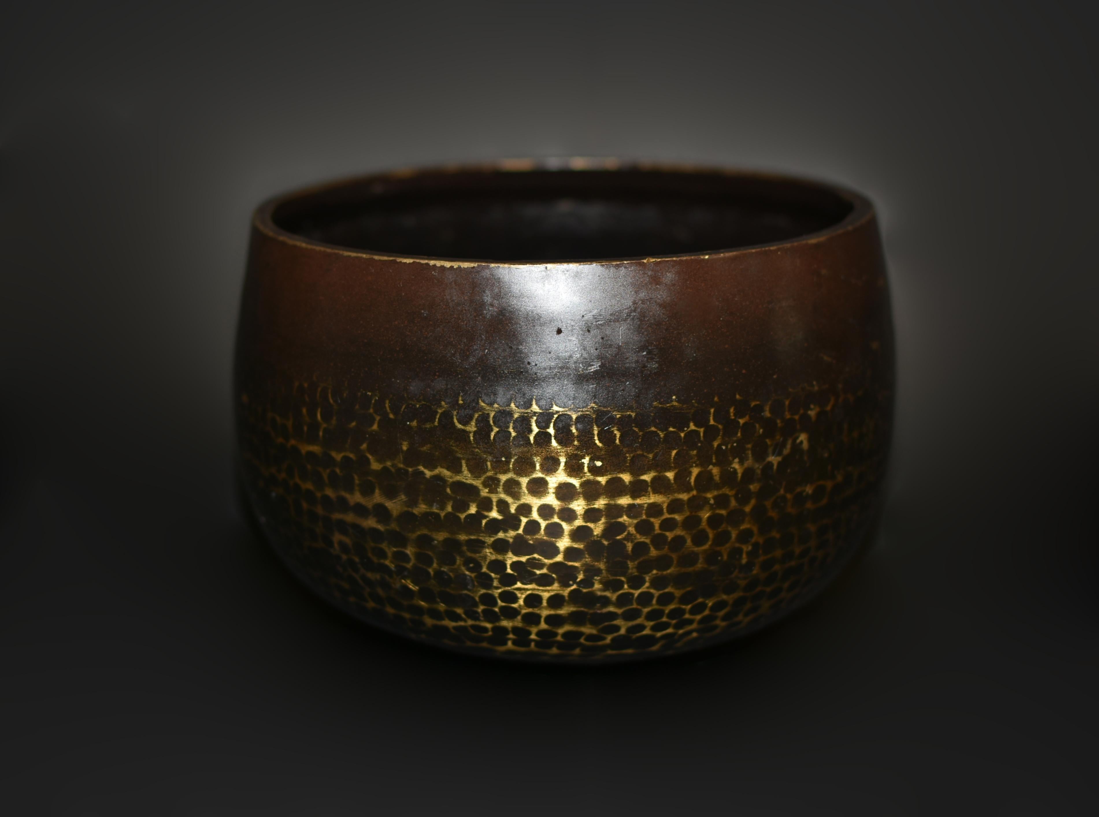 An early 20th century singing bowl crafted from solid bronze captures the eye with its hand-hammered surface revealing intricate gold divots. Emitting the harmonious B4 note, it resonates with the essence of the crown chakra, fostering a profound