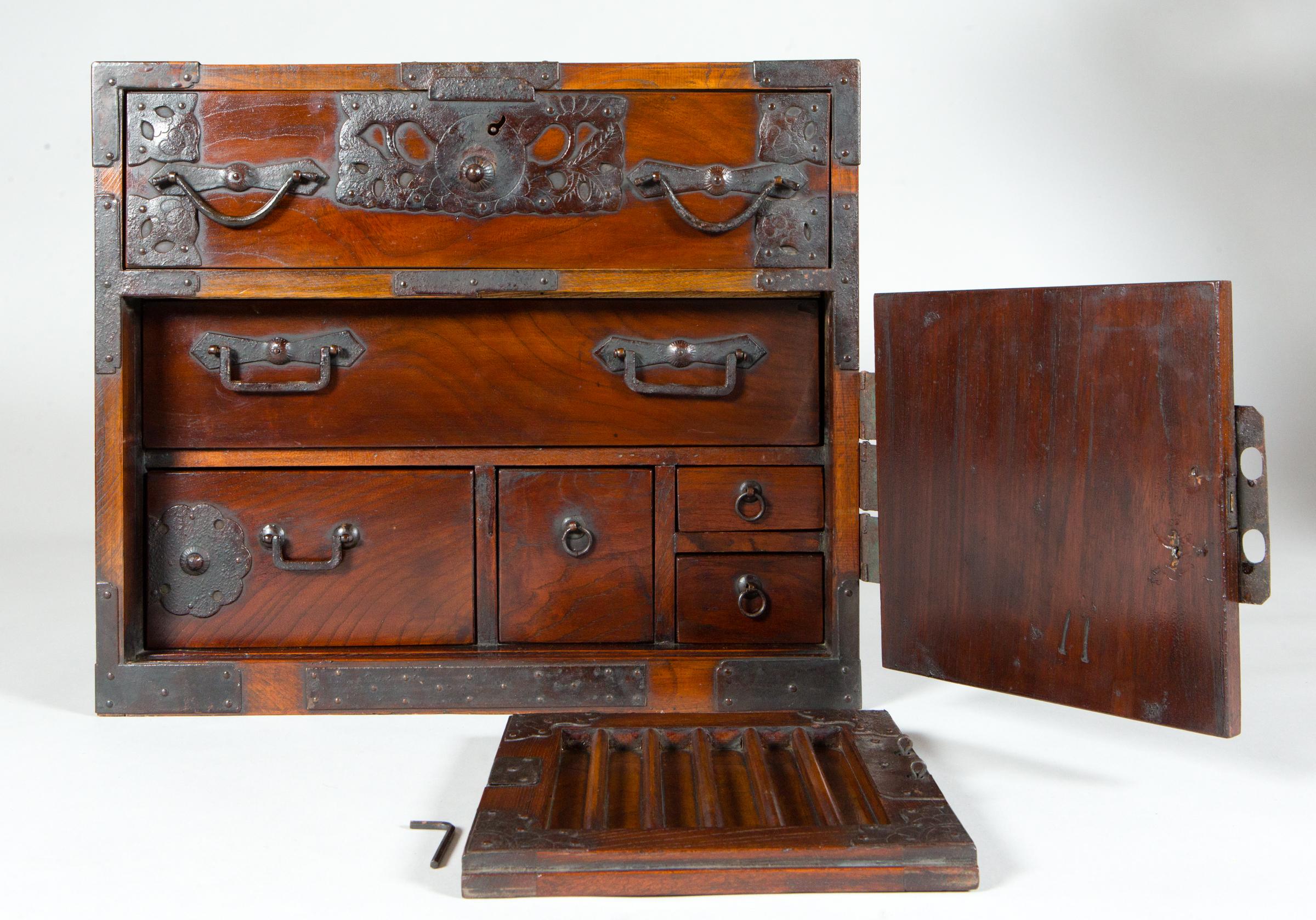 Meiji period (1868-1912) tansu with one drawer on top, a sliding door to reveal 5 more drawers underneath, and 2 locks. Made of keyaki wood, a precious wood in Japan.