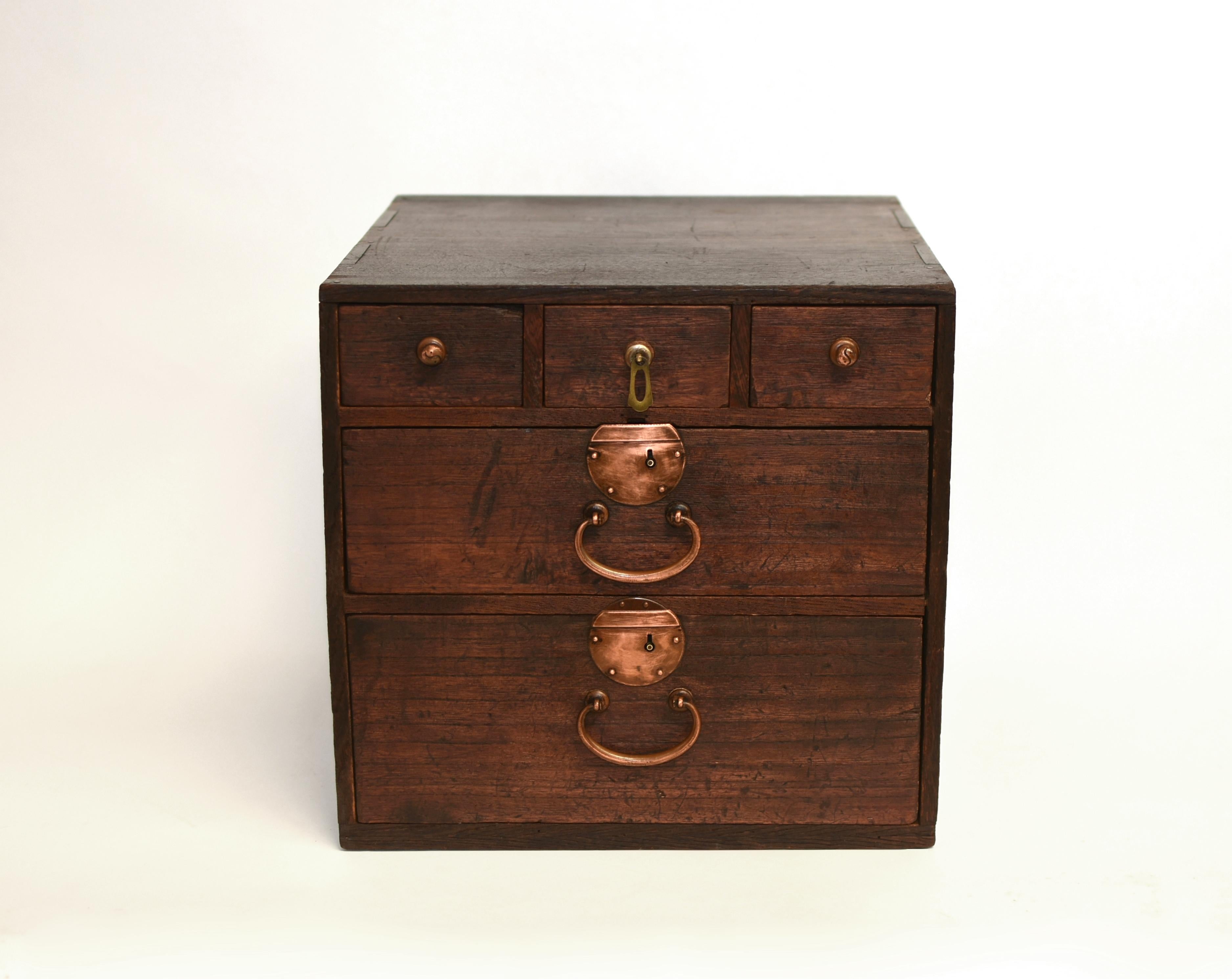 A 19th-century Japanese solid wood Tansu storage chest in excellent condition, exemplifying fine craftsmanship and timeless design. Featuring three small drawers and two large drawers, all full depth to maximize storage capacity. All sides of the