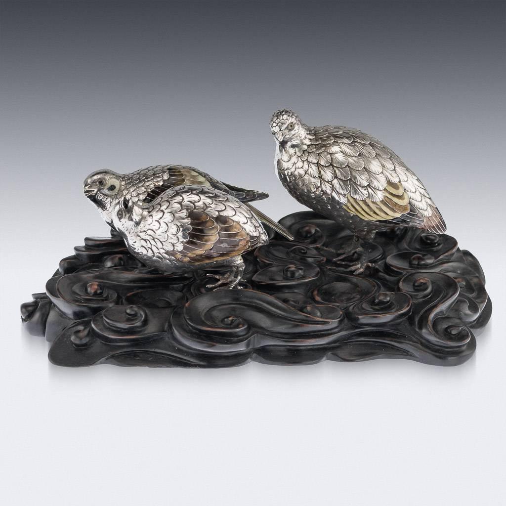 Antique late 19th century Japanese Meiji period very fine silver figures of quails, on a carved wood stand. The naturalistically modeled birds decorated with enamelled eyes and plumage, with realistically engraved feathers. Tested to be 950+ high